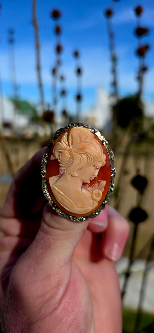 A generously sized vintage 1940’s Art Deco-era cameo brooch / pendant, beautifully hand-carved from natural conch shell, and set in a shimmering sterling silver frame adorned with marcasites.