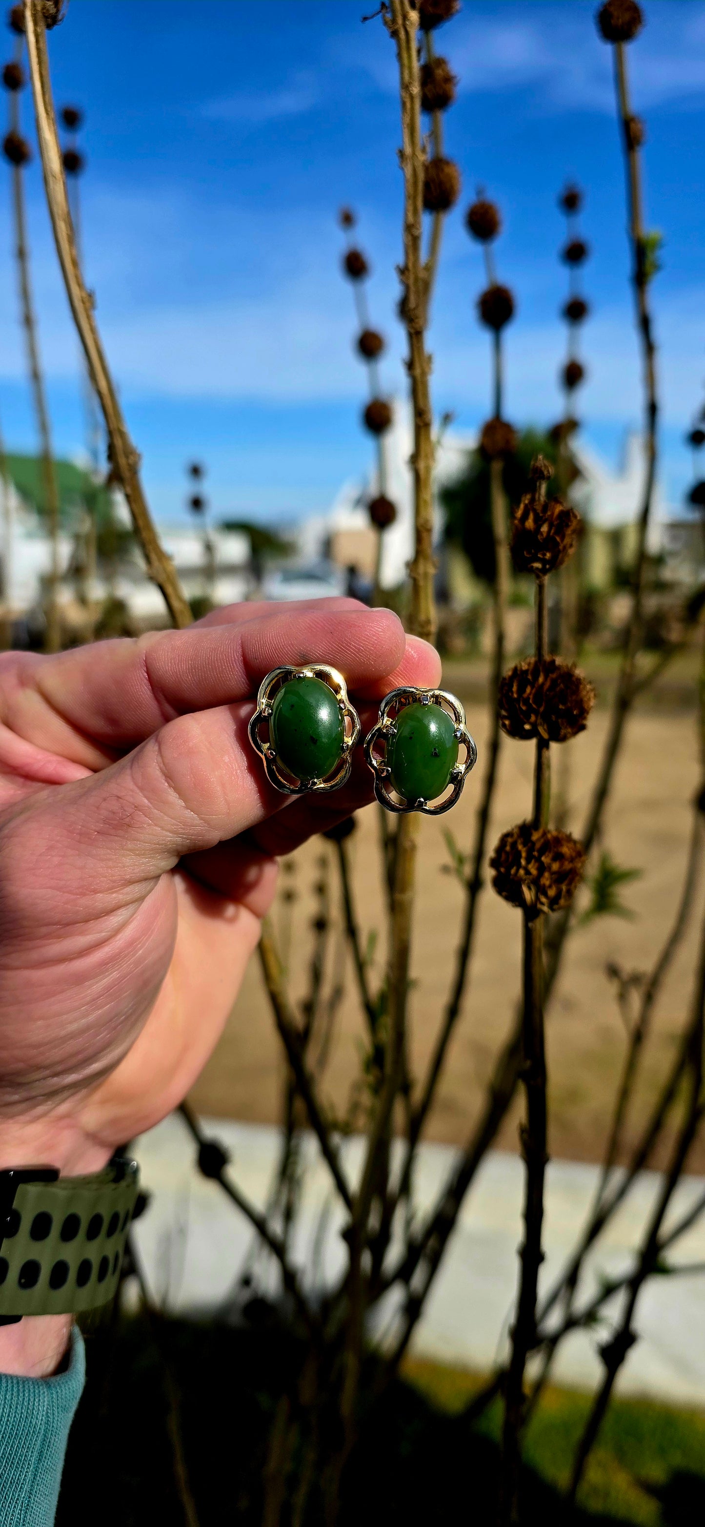 Beautiful pair of vintage designer clip-on earrings crafted in rich yellow gold-filled metal and prong set with glowing oval-shaped Nephrite Jade cabochons in the highly sought-after “Spinach Jade” variety.