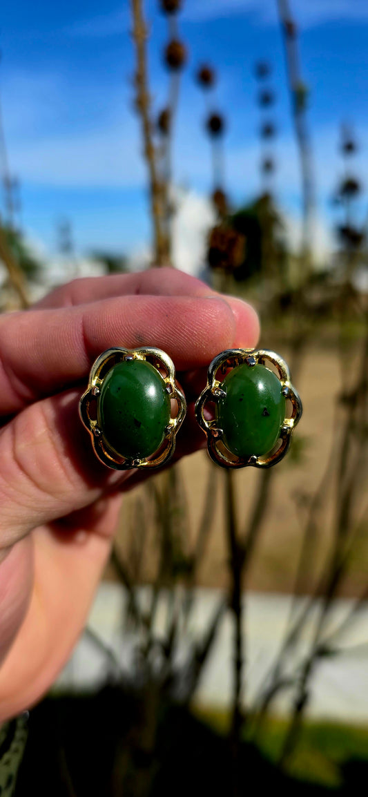 Beautiful pair of vintage designer clip-on earrings crafted in rich yellow gold-filled metal and prong set with glowing oval-shaped Nephrite Jade cabochons in the highly sought-after “Spinach Jade” variety.