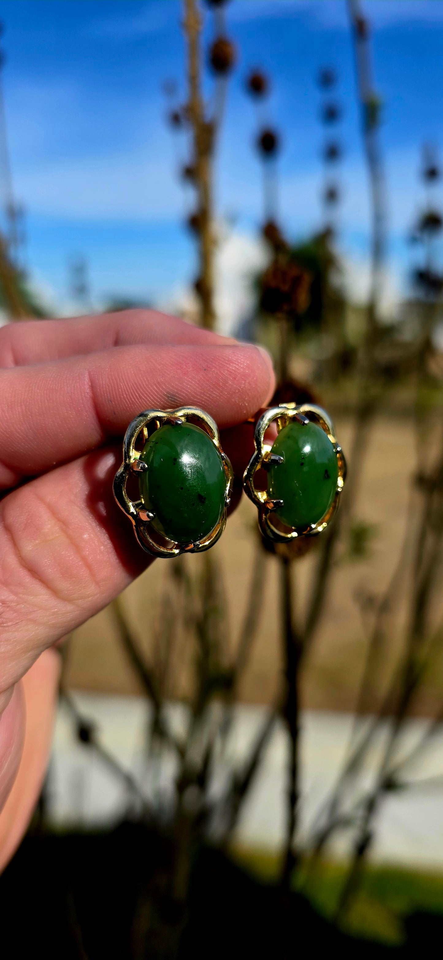 Beautiful pair of vintage designer clip-on earrings crafted in rich yellow gold-filled metal and prong set with glowing oval-shaped Nephrite Jade cabochons in the highly sought-after “Spinach Jade” variety.