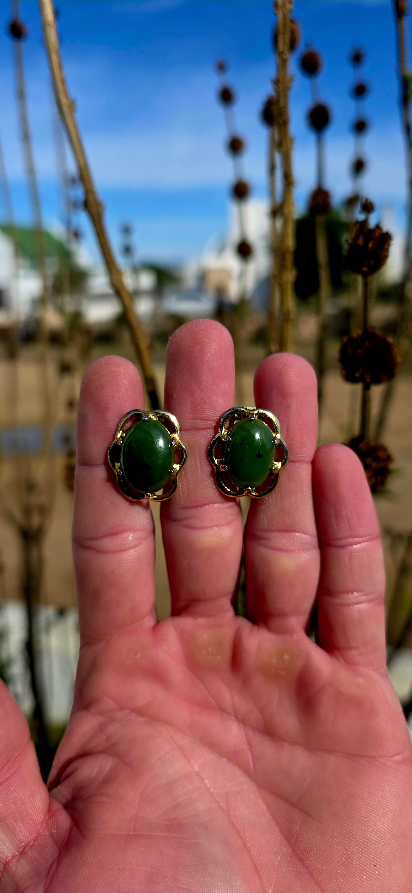 Beautiful pair of vintage designer clip-on earrings crafted in rich yellow gold-filled metal and prong set with glowing oval-shaped Nephrite Jade cabochons in the highly sought-after “Spinach Jade” variety.