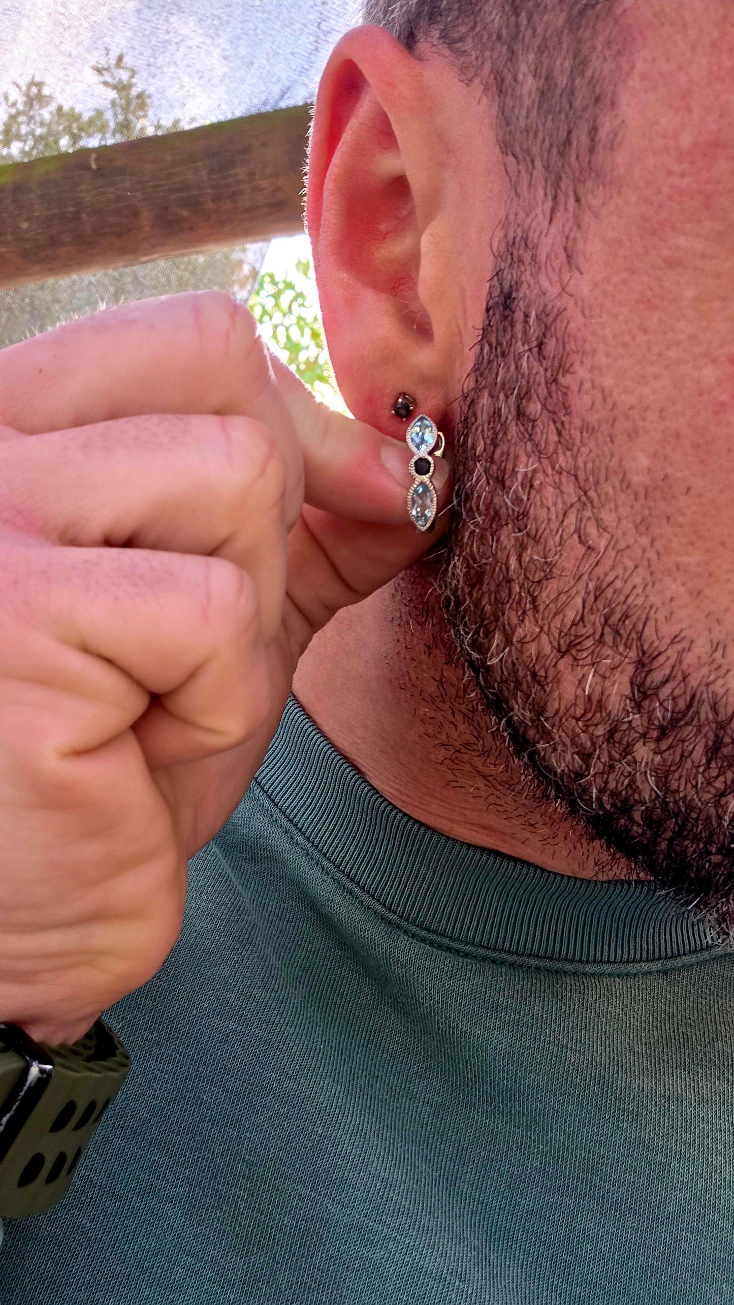 Crafted in sterling silver, these beautiful half-hoop dress earrings feature a graceful vertical arrangement of faceted marquise-cut sky blue topaz gemstones, separated by a rich dark blue round-cut sapphire at the centre.