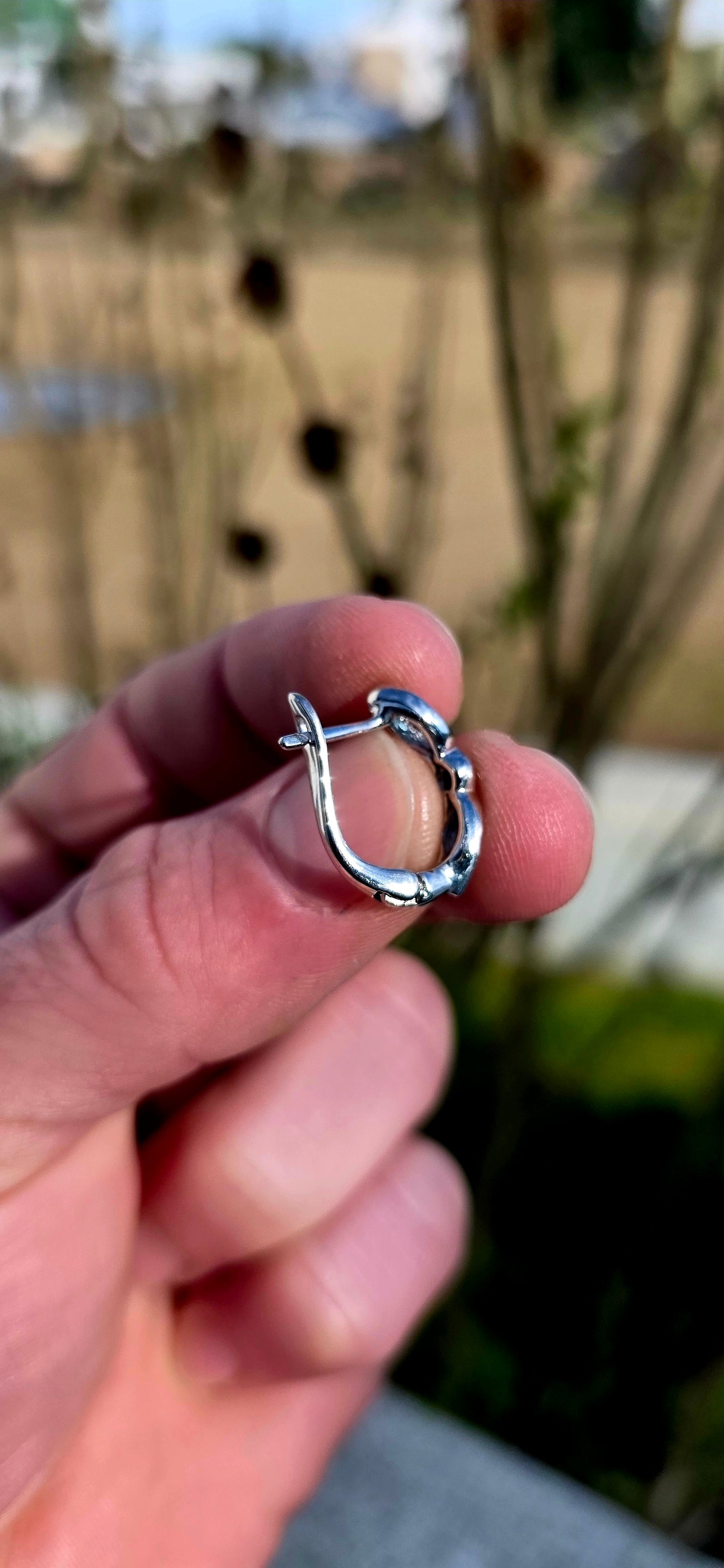 Crafted in sterling silver, these beautiful half-hoop dress earrings feature a graceful vertical arrangement of faceted marquise-cut sky blue topaz gemstones, separated by a rich dark blue round-cut sapphire at the centre.