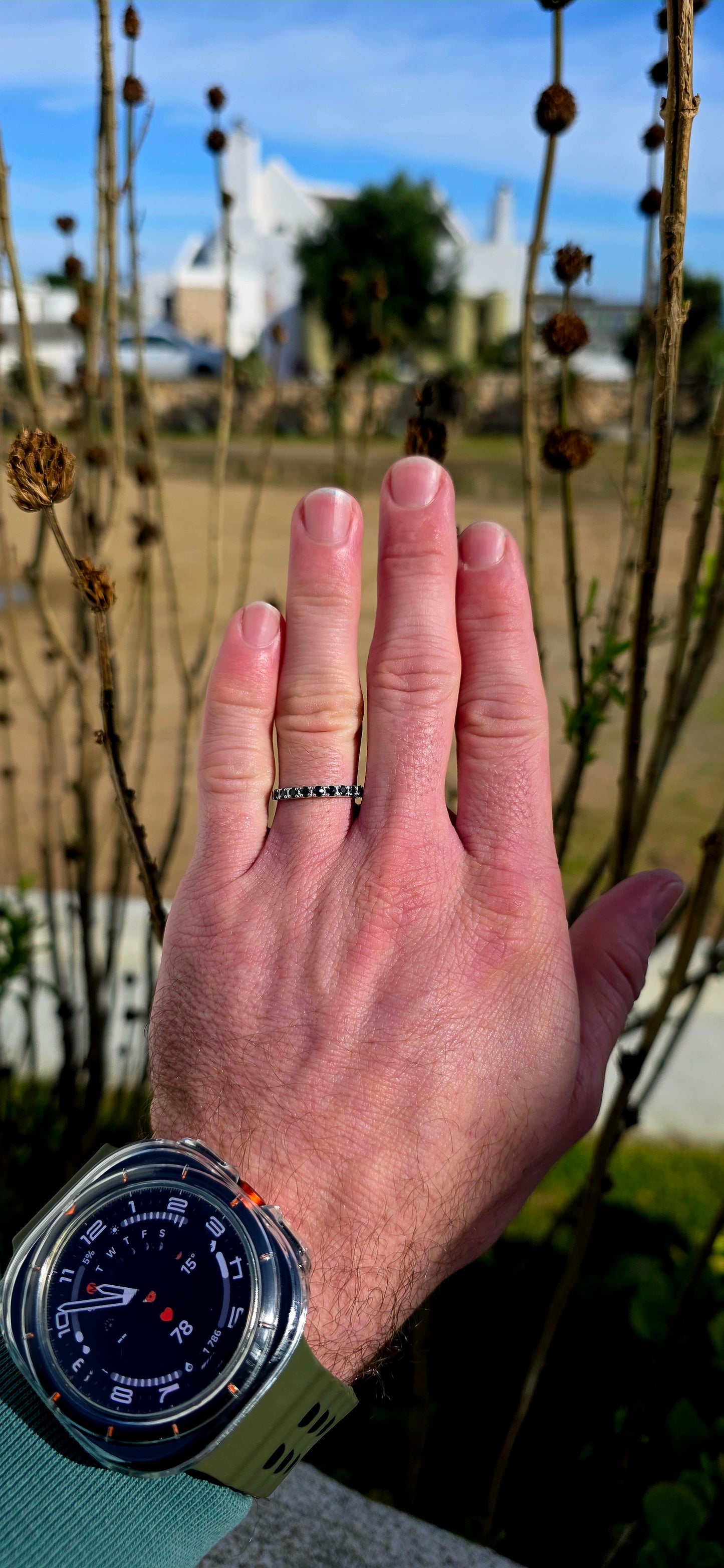 Crafted in sterling silver, this dainty stacking ring is beautifully set with nine round-cut blue sapphires in a delicate combination of prong and flush-style settings.
