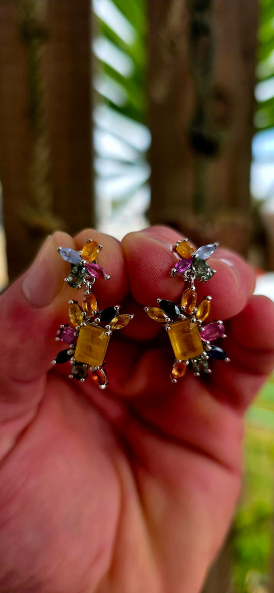 Absolutely enchanting and bursting with joyful colour .These sterling silver floral-inspired drop earrings are a true celebration of vibrant gemstones and playful elegance.