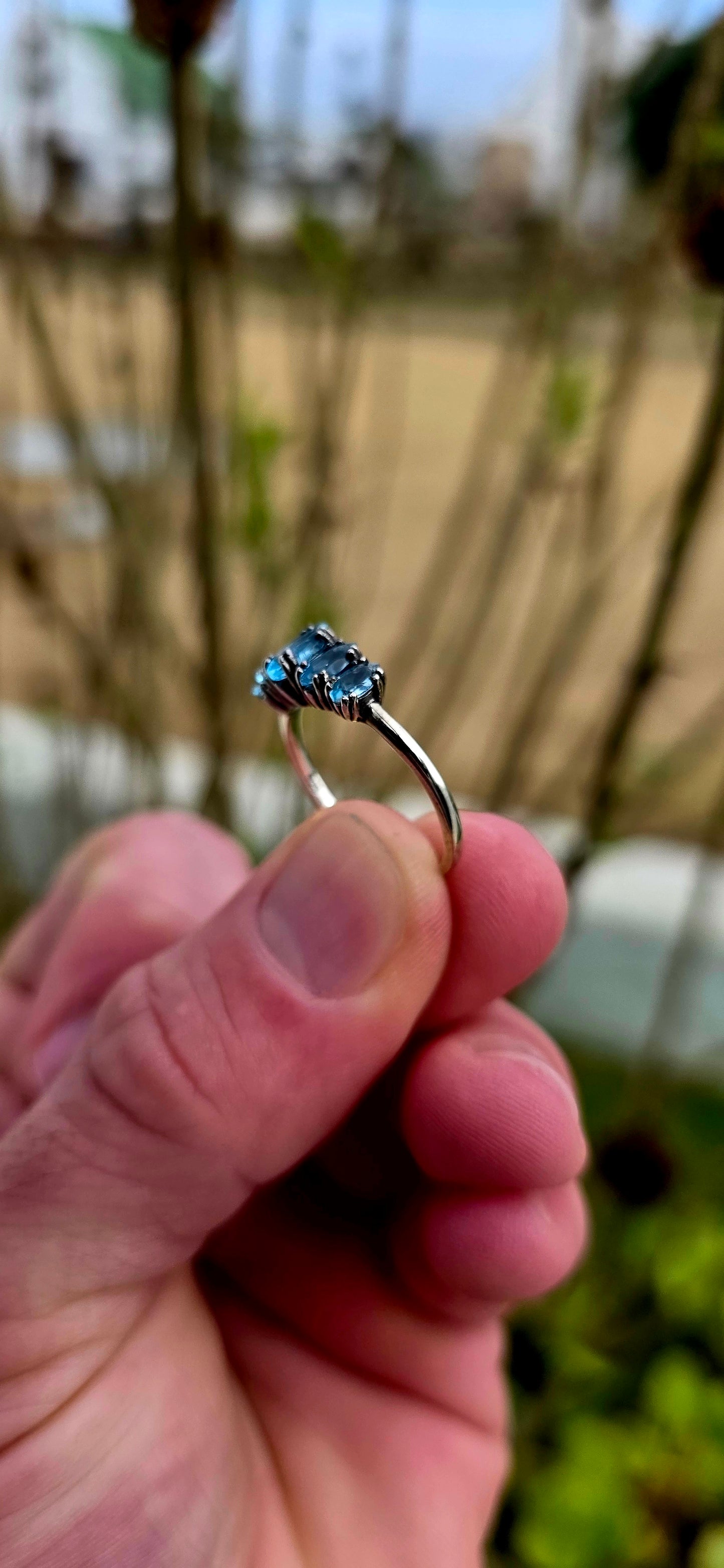 Delicate, dreamy, and filled with icy sparkle… this enchanting sterling silver ring is adorned with five marquise-cut sky blue topaz gemstones arranged in a graceful crown-like formation.
