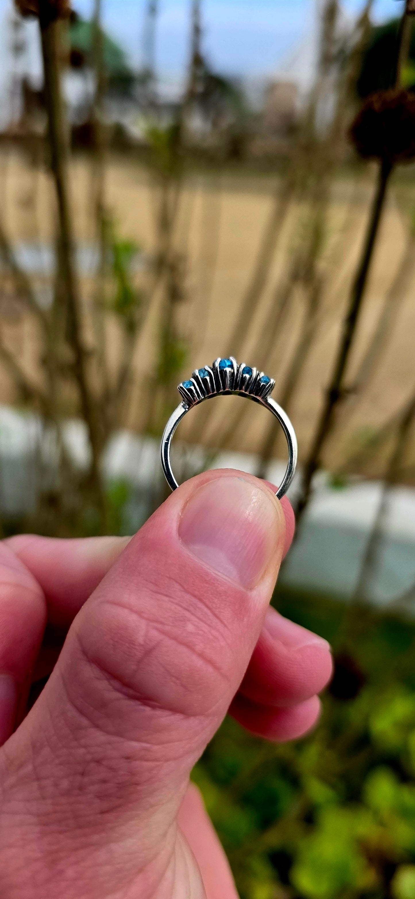 Delicate, dreamy, and filled with icy sparkle… this enchanting sterling silver ring is adorned with five marquise-cut sky blue topaz gemstones arranged in a graceful crown-like formation.