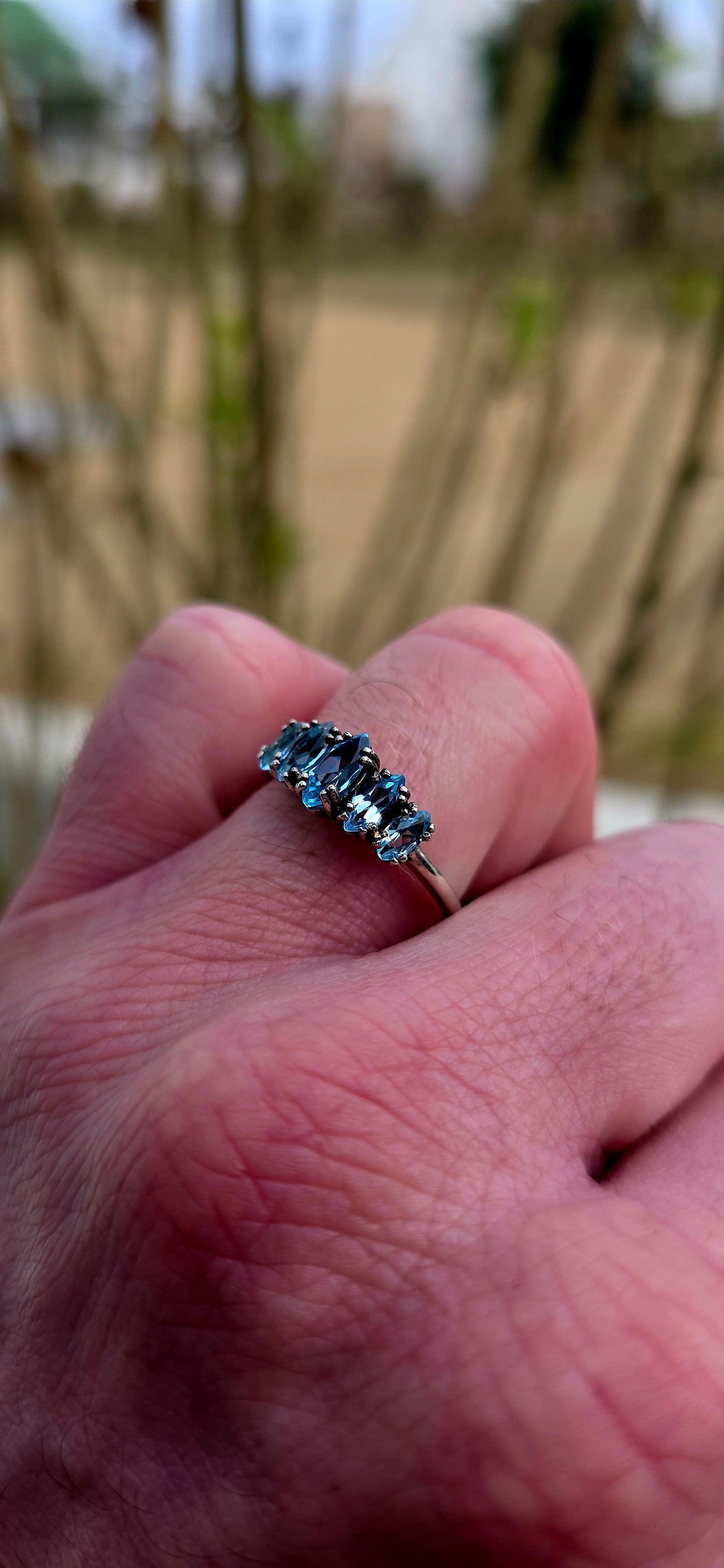 Delicate, dreamy, and filled with icy sparkle… this enchanting sterling silver ring is adorned with five marquise-cut sky blue topaz gemstones arranged in a graceful crown-like formation.
