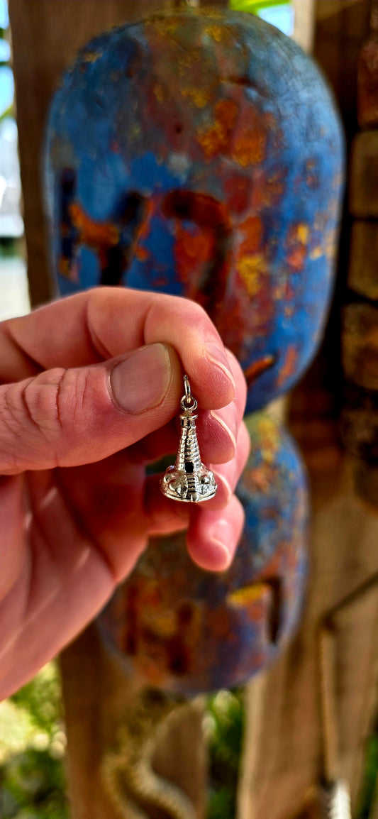Up for grabs is the most magical vintage sterling silver articulated charm in the shape of a tiny lighthouse .