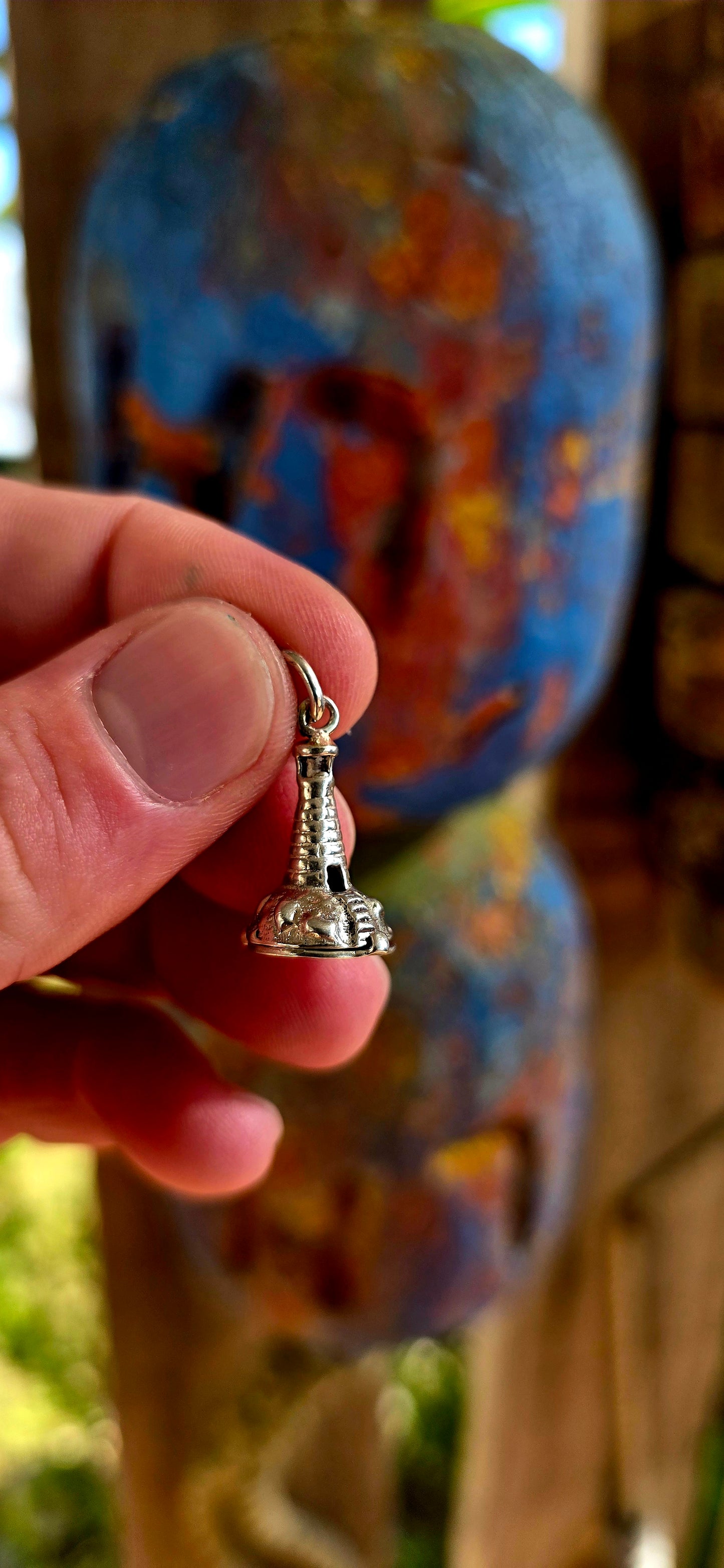 Up for grabs is the most magical vintage sterling silver articulated charm in the shape of a tiny lighthouse .
