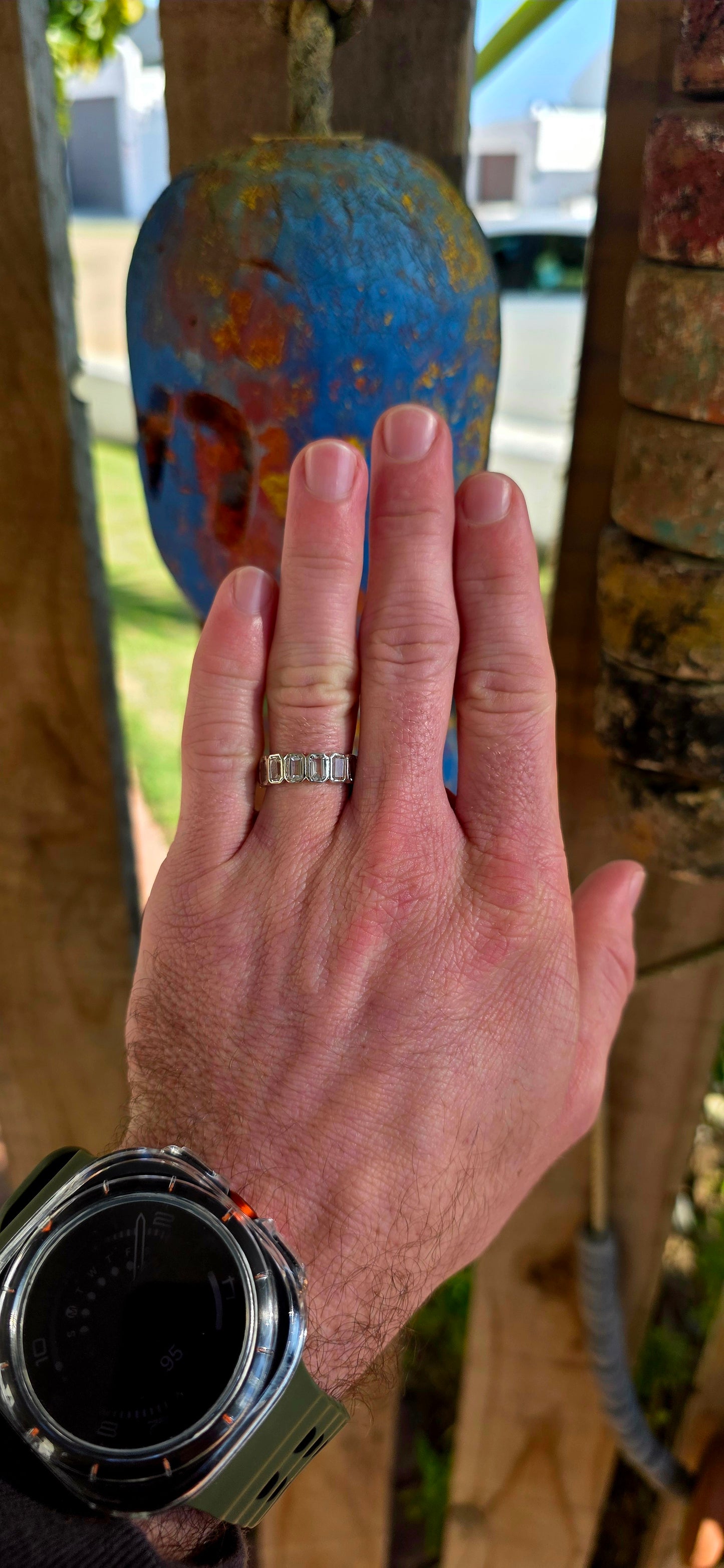 A truly breathtaking sterling silver full eternity ring, shimmering with fourteen emerald-cut white topaz gemstones set continuously all the way around the band in sleek tube settings.