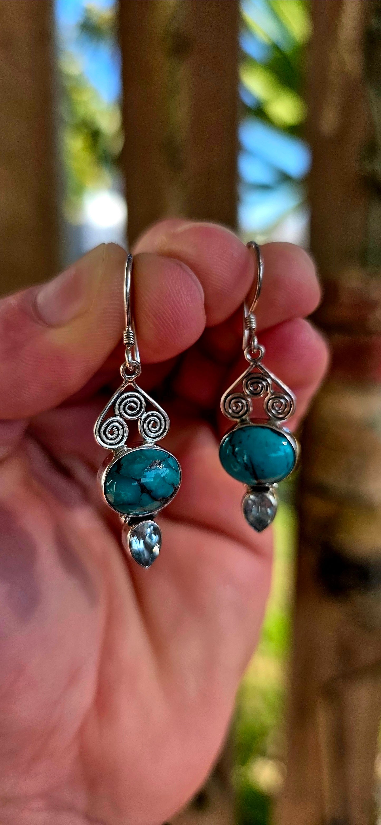 Crafted in sterling silver, the earrings feature beautiful tube-set oval turquoise cabochons displaying those dreamy natural black matrix patterns that make every turquoise stone completely unique .