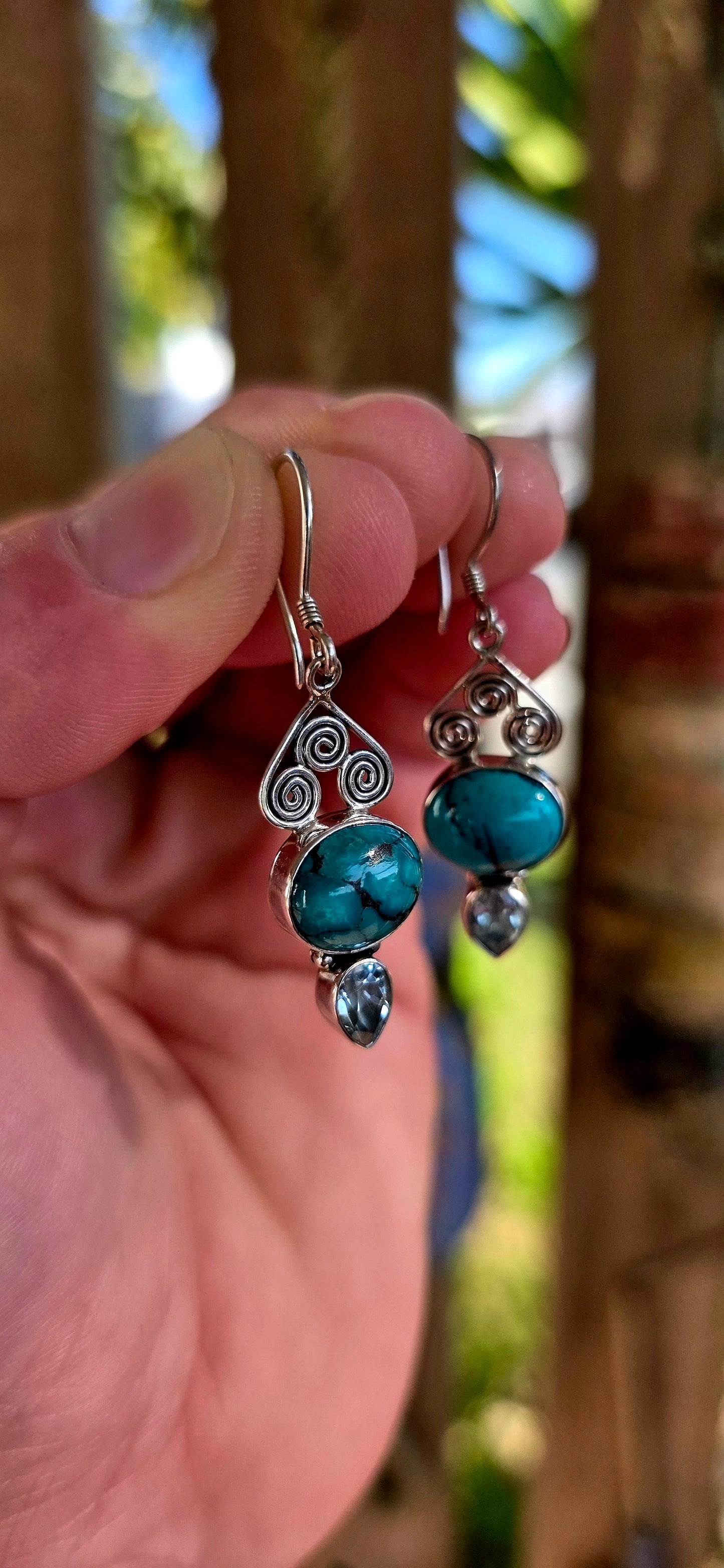 Crafted in sterling silver, the earrings feature beautiful tube-set oval turquoise cabochons displaying those dreamy natural black matrix patterns that make every turquoise stone completely unique .