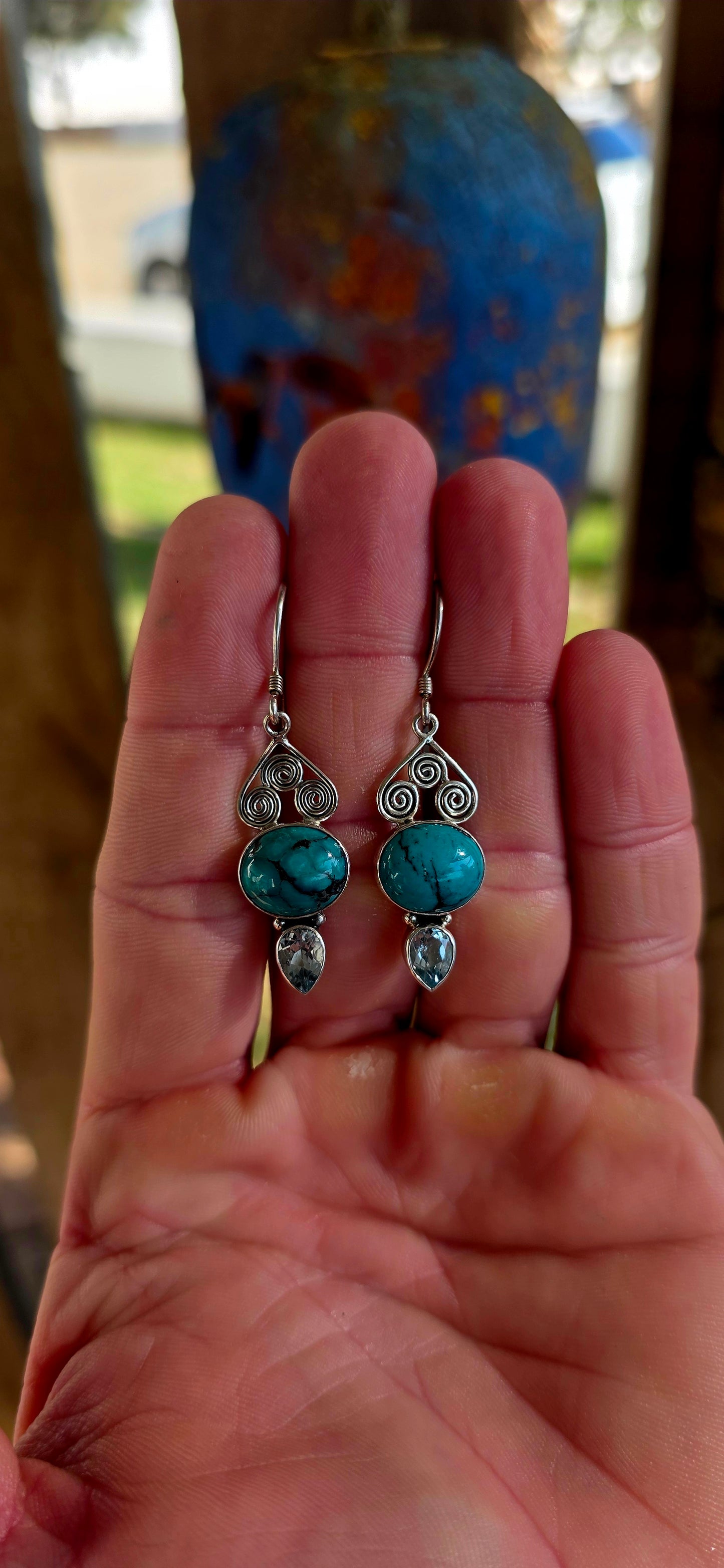 Crafted in sterling silver, the earrings feature beautiful tube-set oval turquoise cabochons displaying those dreamy natural black matrix patterns that make every turquoise stone completely unique .