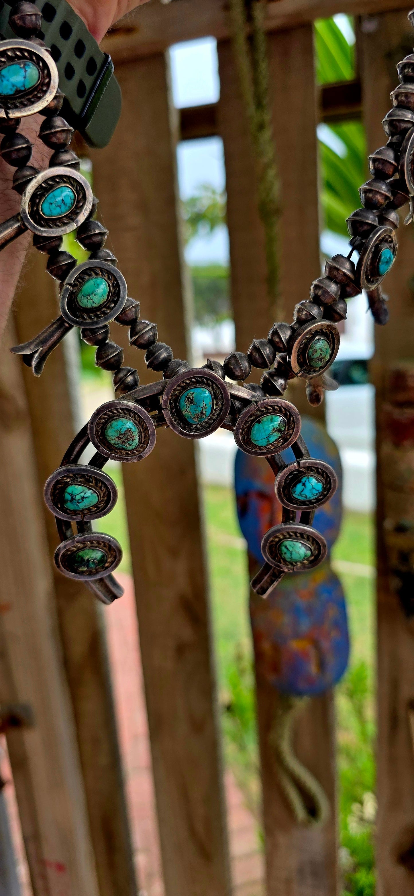 An absolutely breathtaking and exceptionally rare vintage Native American Navajo squash blossom necklace, masterfully handcrafted in sterling silver and adorned with vivid turquoise cabochons throughout.