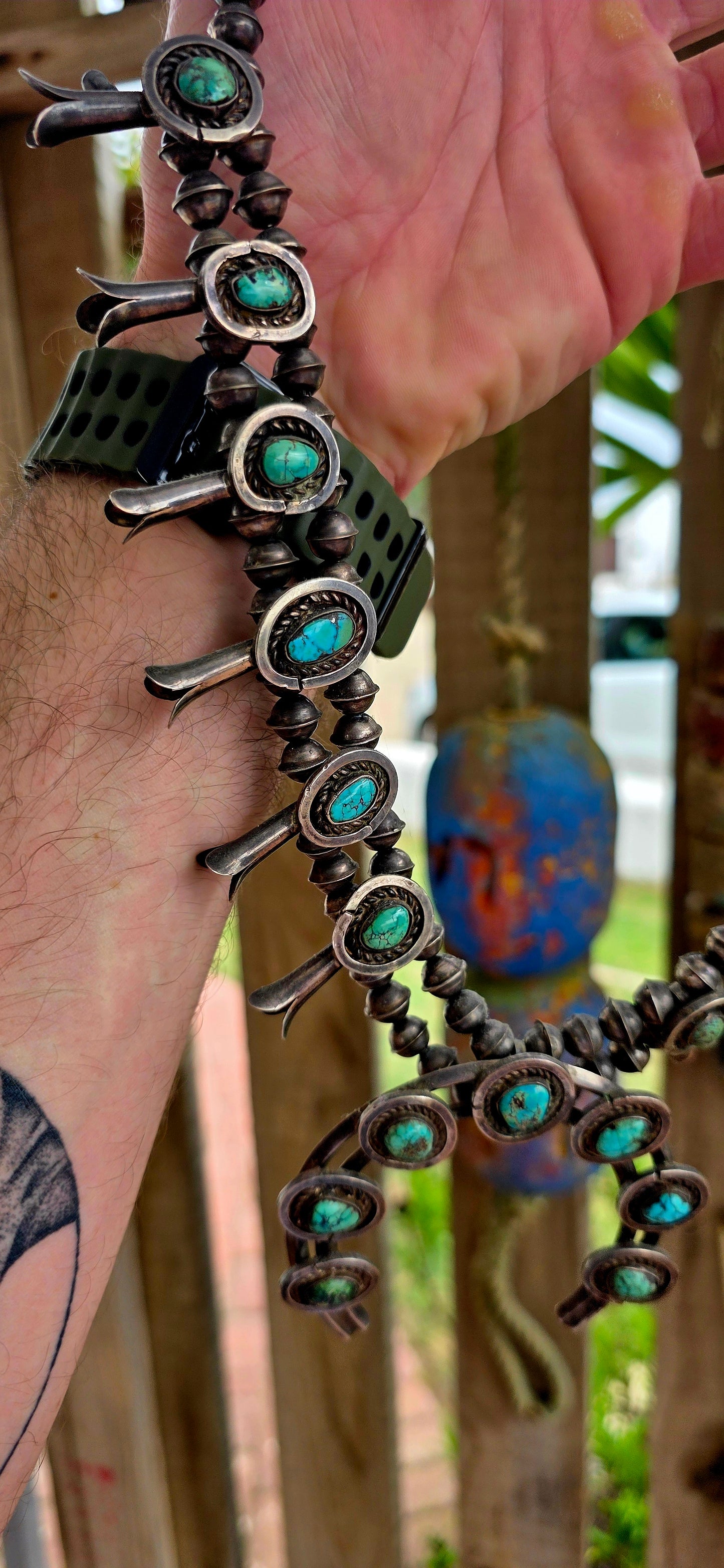 An absolutely breathtaking and exceptionally rare vintage Native American Navajo squash blossom necklace, masterfully handcrafted in sterling silver and adorned with vivid turquoise cabochons throughout.