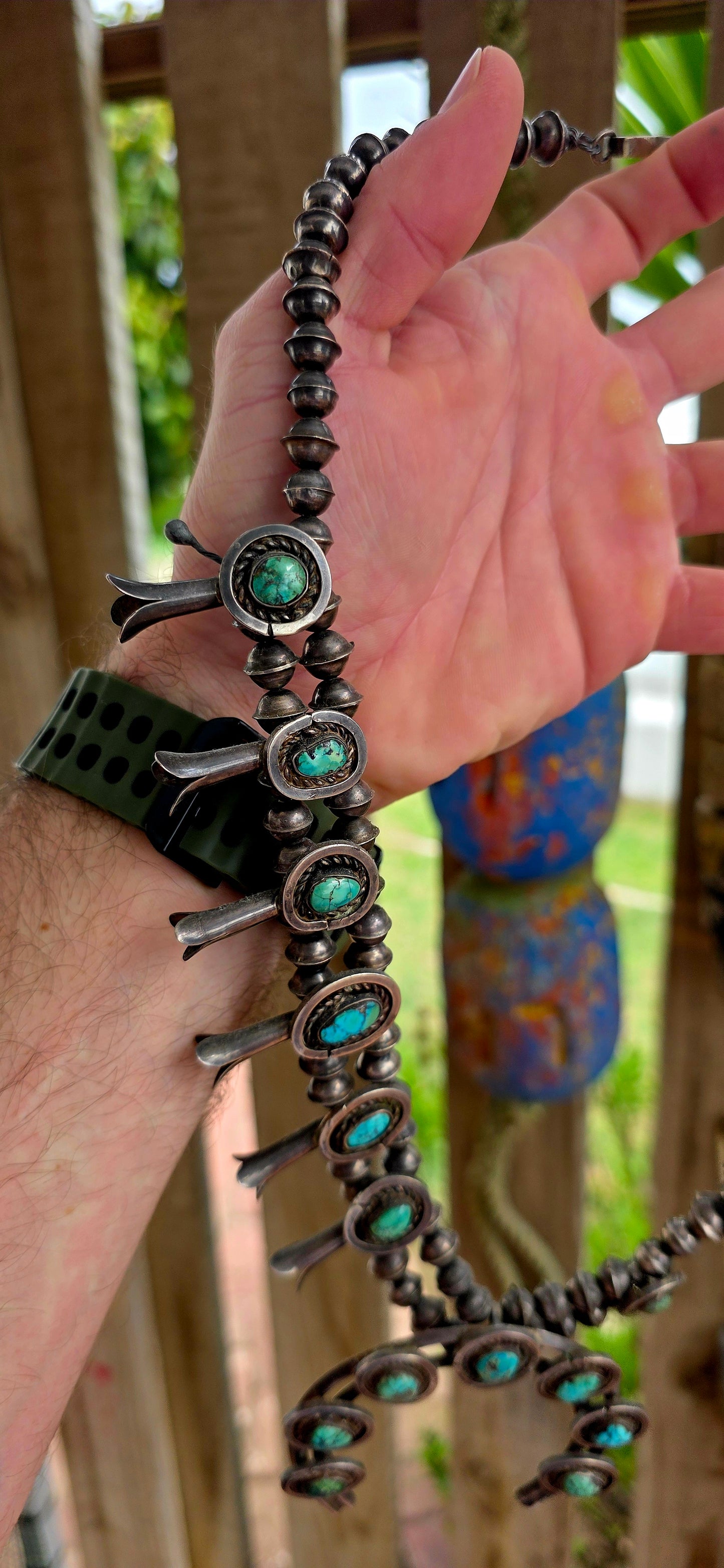 An absolutely breathtaking and exceptionally rare vintage Native American Navajo squash blossom necklace, masterfully handcrafted in sterling silver and adorned with vivid turquoise cabochons throughout.