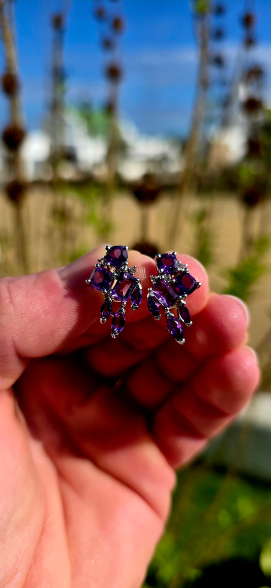 Bold, glamorous and bursting with royal colour...
Crafted in sterling silver, each earring is adorned with a dazzling arrangement of richly coloured amethyst gemstones in a beautiful variety of cuts.