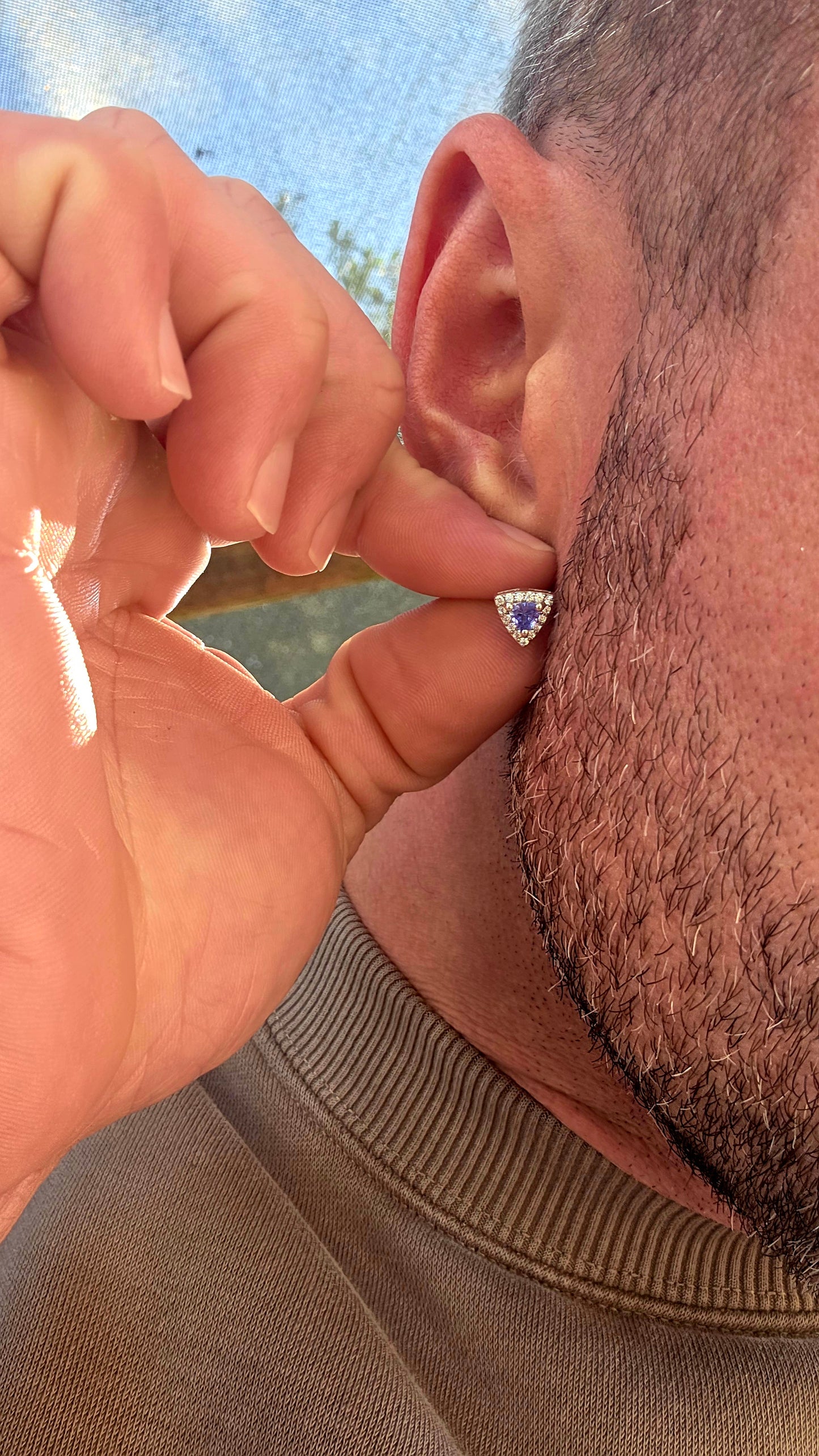 Crafted in sterling silver, these elegant stud earrings feature beautiful prong-set trillion cut tanzanites glowing in rich shades of violet-blue, indigo, and twilight lavender .