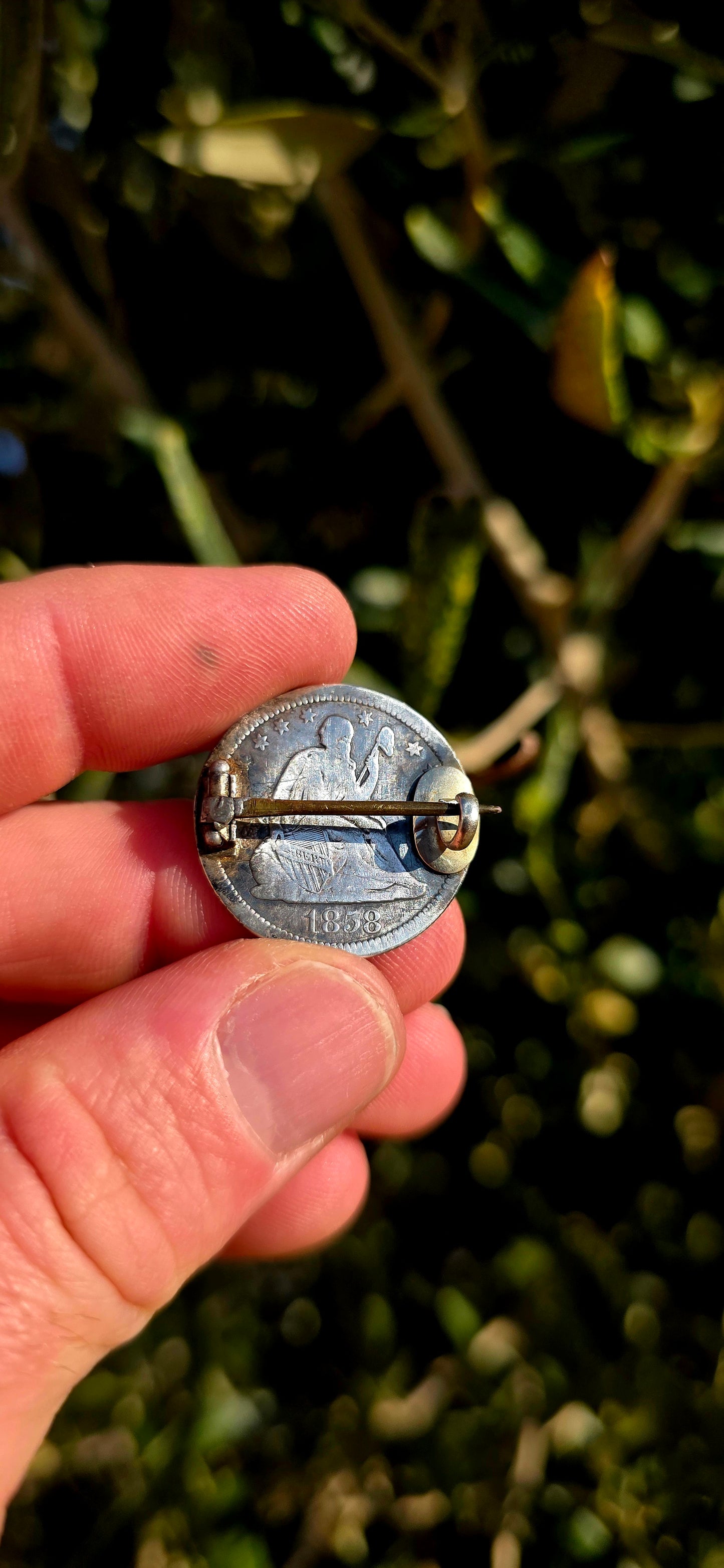 A wonderfully sentimental survivor from the Victorian era, this antique sweetheart brooch was lovingly handcrafted from an authentic American silver coin dated 1858.