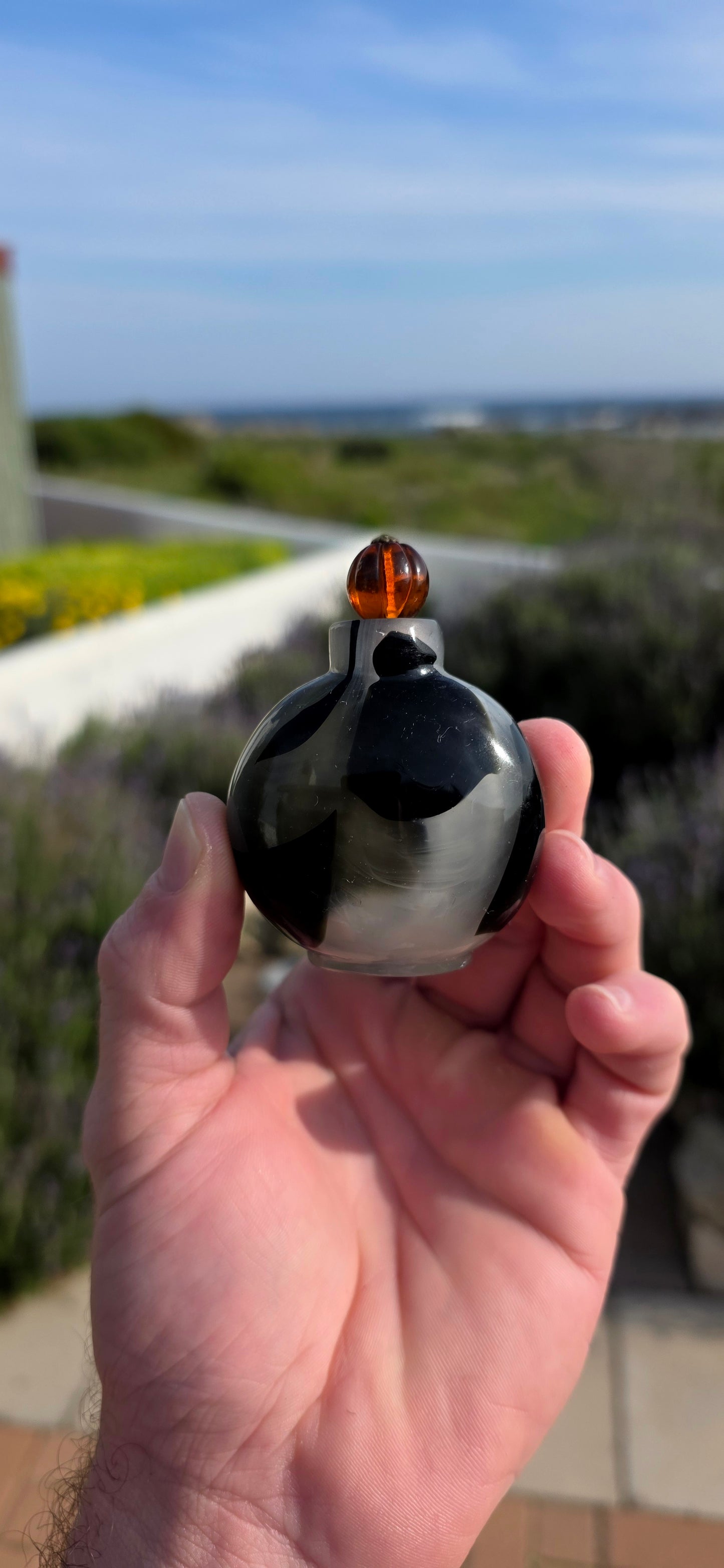 This rare 19th-century Chinese snuff bottle has been expertly crafted from striking marbled glass designed to imitate natural banded agate, a highly prized material in traditional Chinese decorative arts.