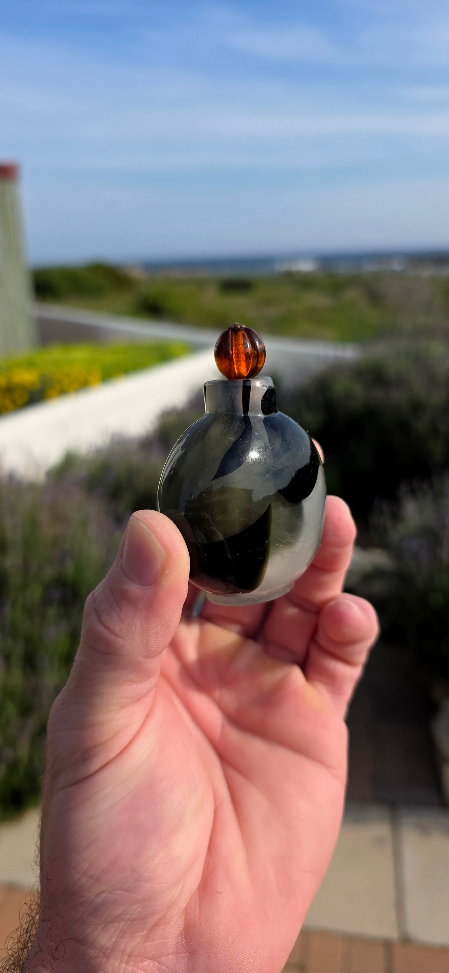 This rare 19th-century Chinese snuff bottle has been expertly crafted from striking marbled glass designed to imitate natural banded agate, a highly prized material in traditional Chinese decorative arts.