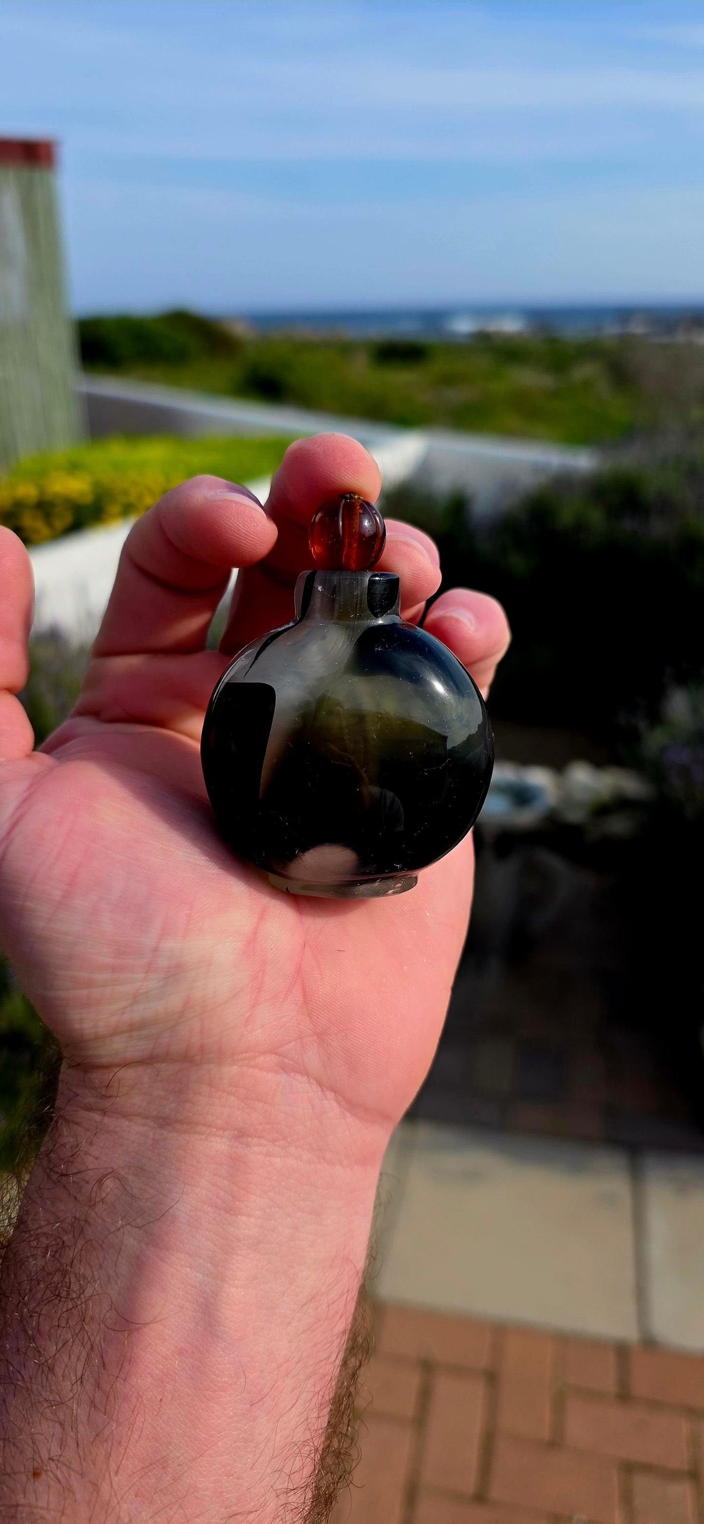 This rare 19th-century Chinese snuff bottle has been expertly crafted from striking marbled glass designed to imitate natural banded agate, a highly prized material in traditional Chinese decorative arts.