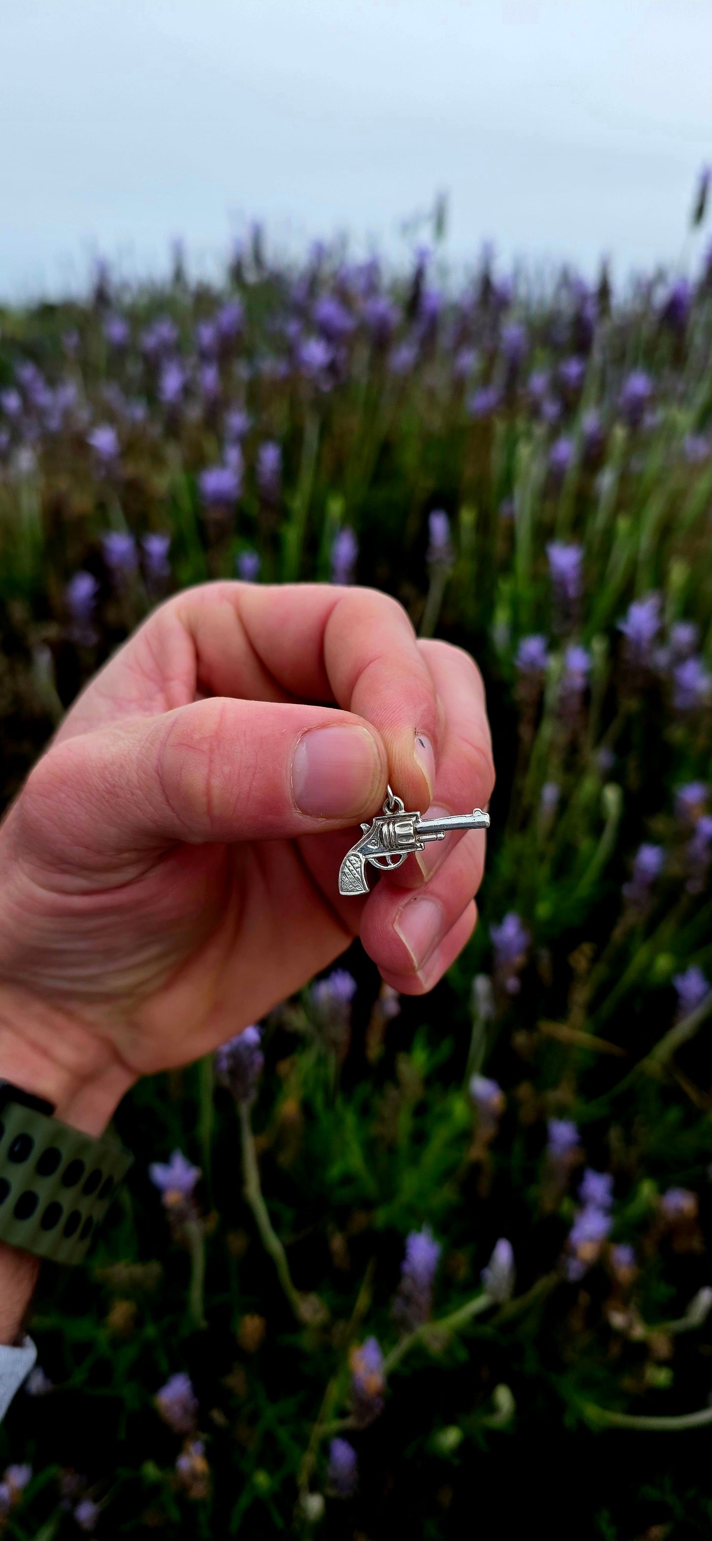 A wonderfully detailed vintage sterling silver charm crafted in the shape of a classic revolver-style pistol.