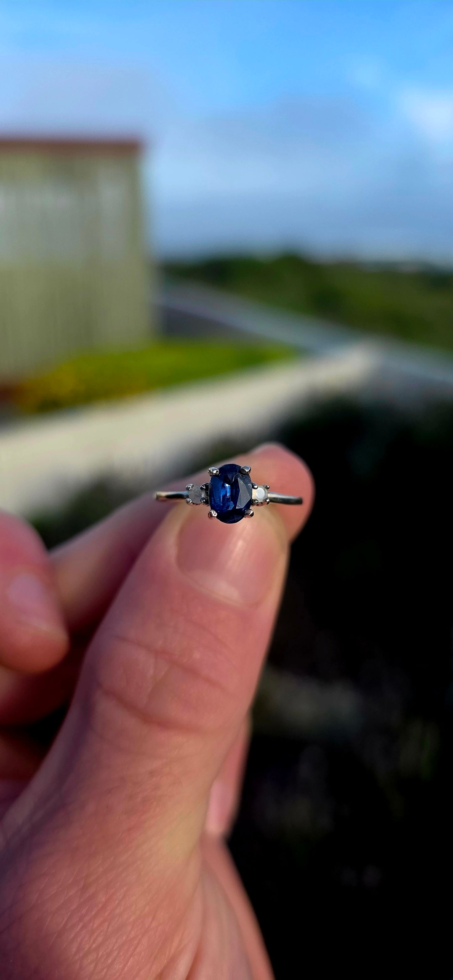 Crafted in sterling silver, this elegant trilogy ring features a captivating oval-cut natural kyanite gemstone at its centre, secured within a classic prong setting.