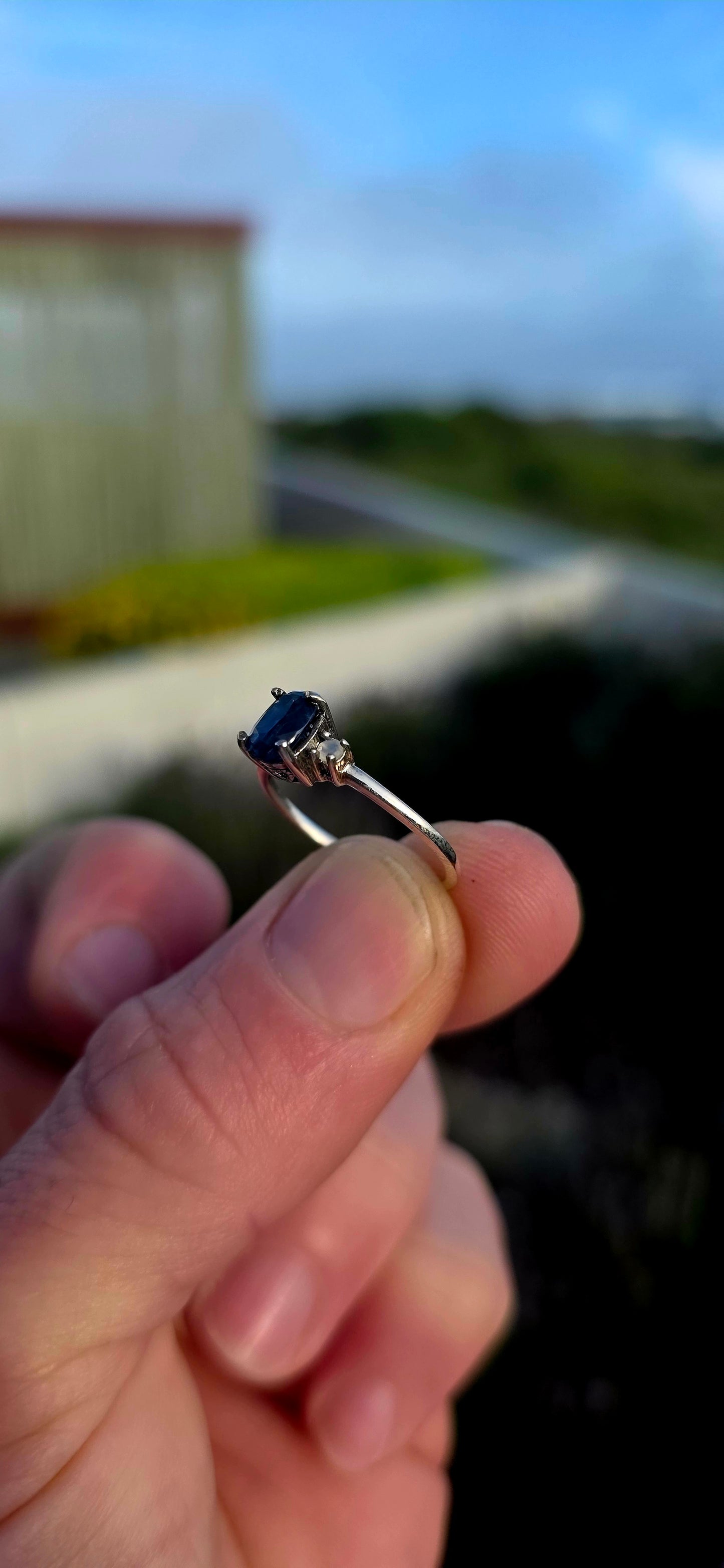 Crafted in sterling silver, this elegant trilogy ring features a captivating oval-cut natural kyanite gemstone at its centre, secured within a classic prong setting.
