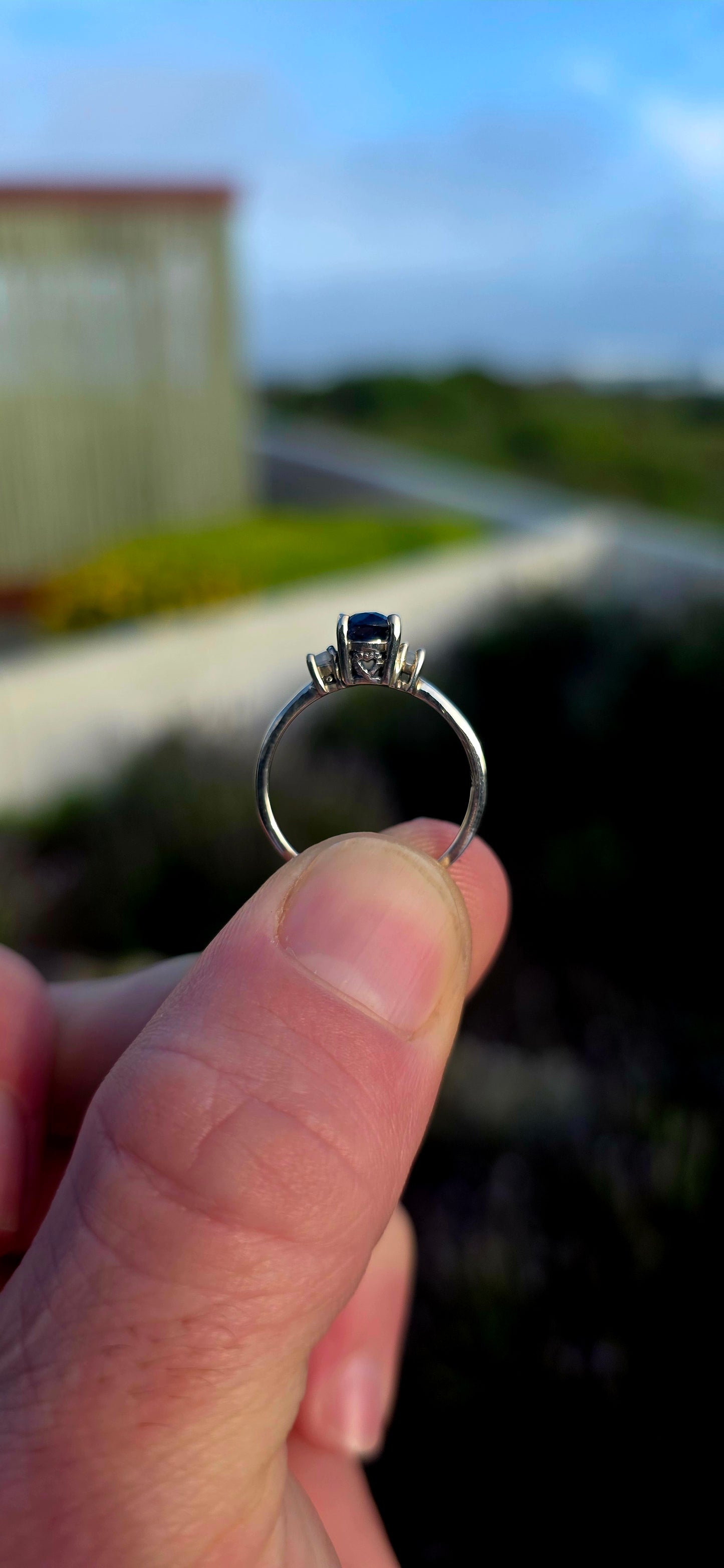 Crafted in sterling silver, this elegant trilogy ring features a captivating oval-cut natural kyanite gemstone at its centre, secured within a classic prong setting.