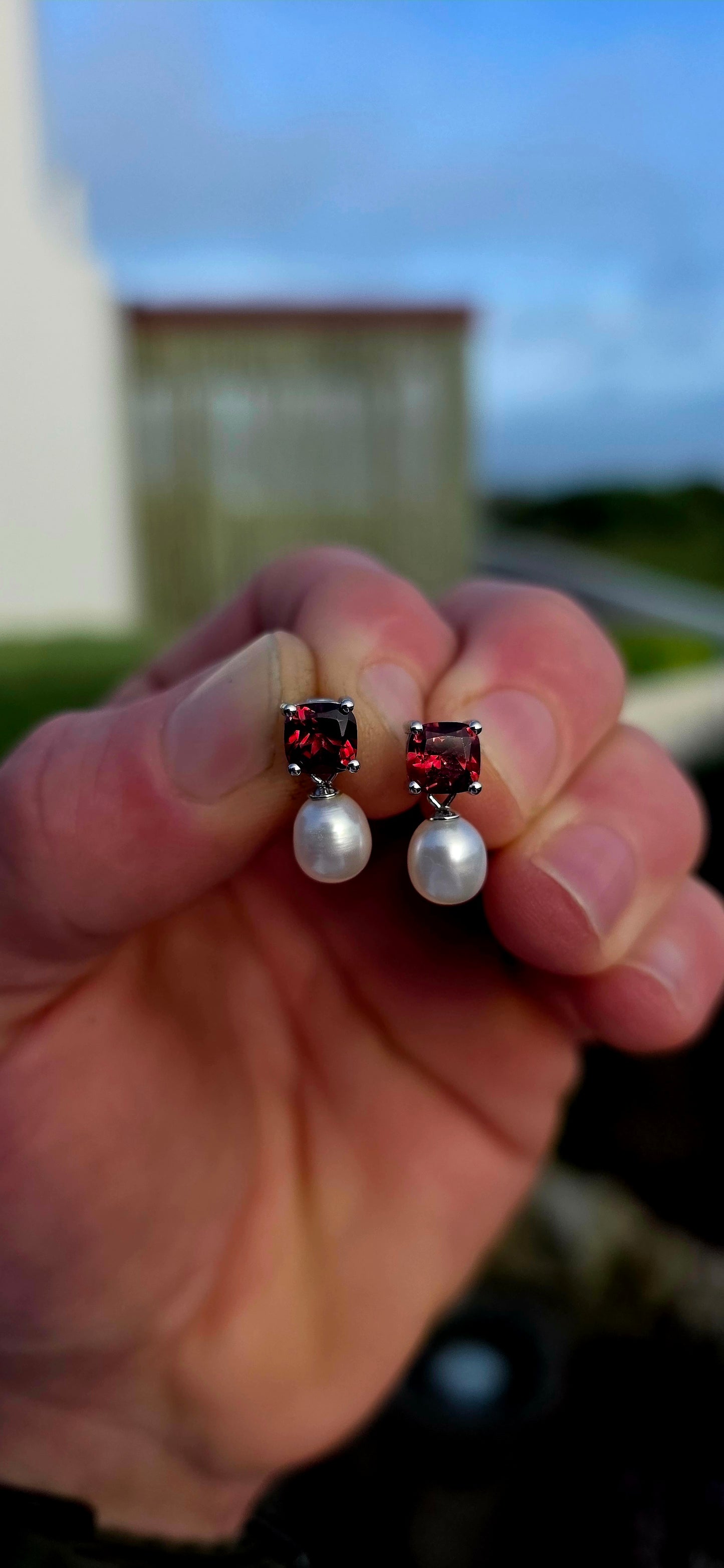 Crafted in sterling silver, these beautiful drop earrings each begin with a richly coloured cushion-cut garnet gemstone, secured in a classic four-prong setting that allows the gemstone's deep crimson sparkle to take centre stage.