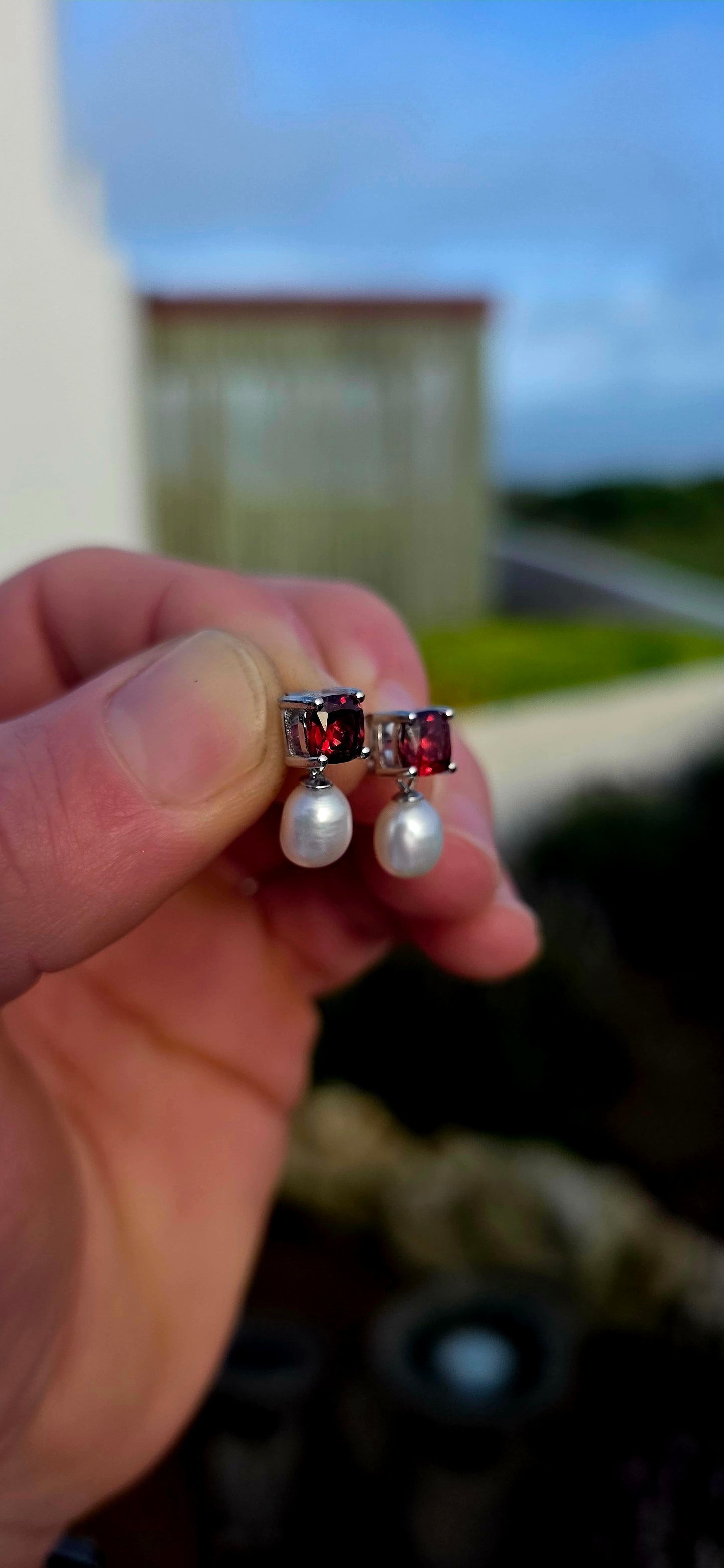 Crafted in sterling silver, these beautiful drop earrings each begin with a richly coloured cushion-cut garnet gemstone, secured in a classic four-prong setting that allows the gemstone's deep crimson sparkle to take centre stage.