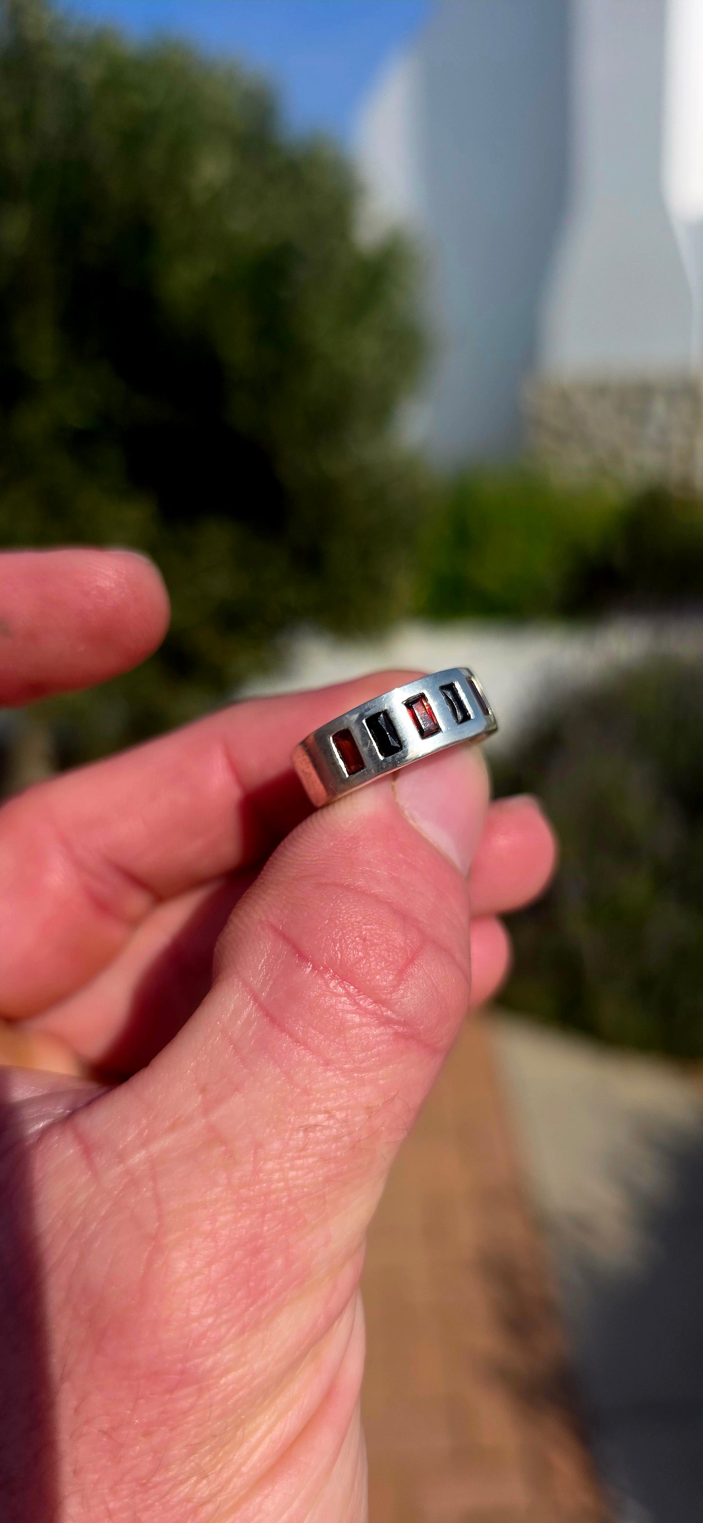 Darkly elegant with a contemporary edge... this striking sterling silver eternity-style band is a piece that blurs the line between classic and modern.