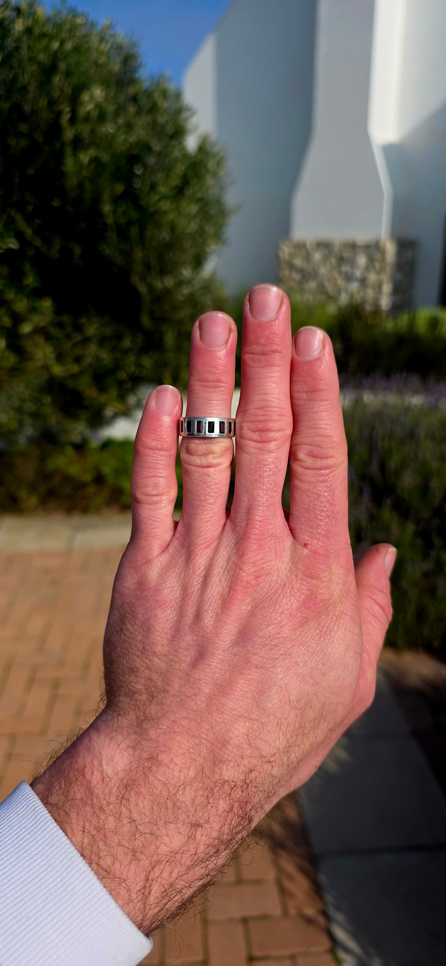 Darkly elegant with a contemporary edge... this striking sterling silver eternity-style band is a piece that blurs the line between classic and modern.