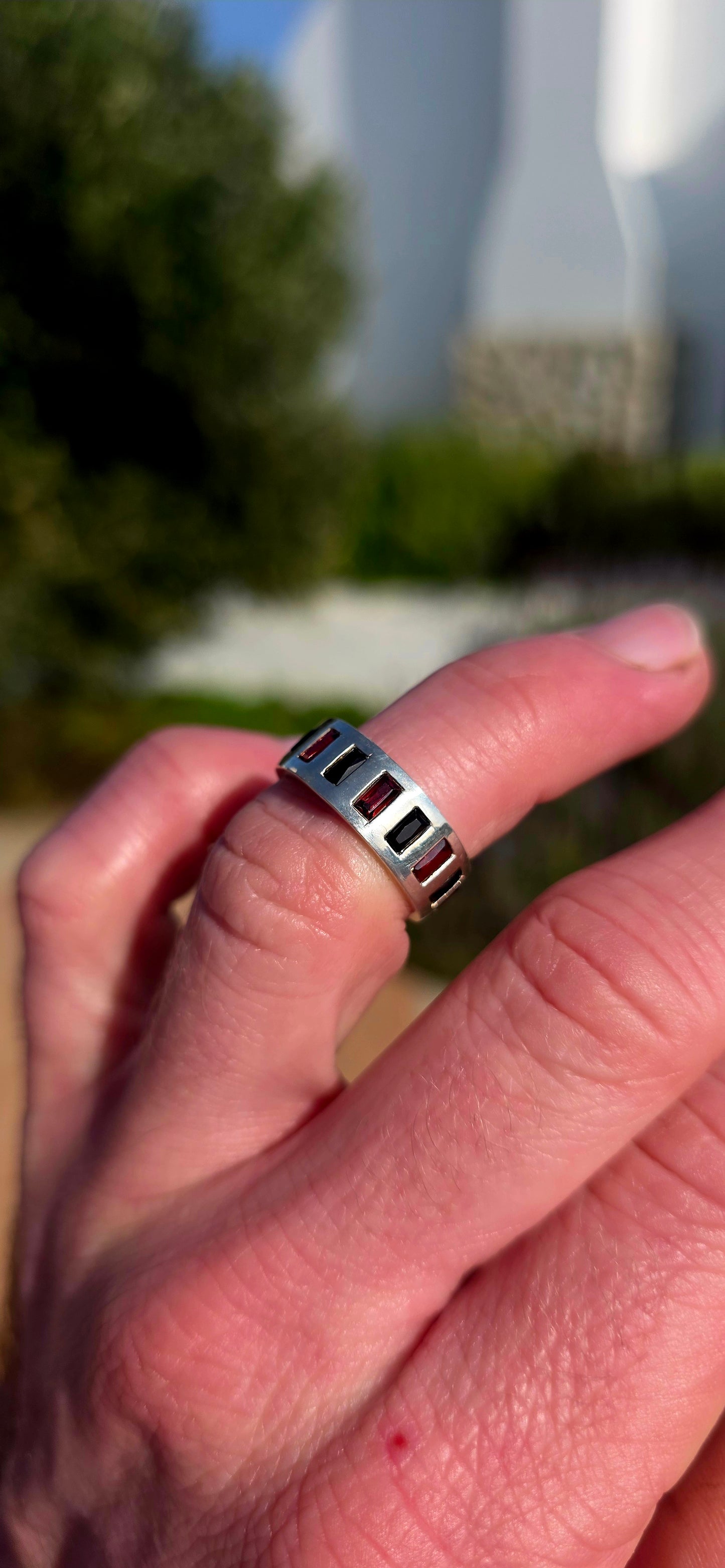 Darkly elegant with a contemporary edge... this striking sterling silver eternity-style band is a piece that blurs the line between classic and modern.