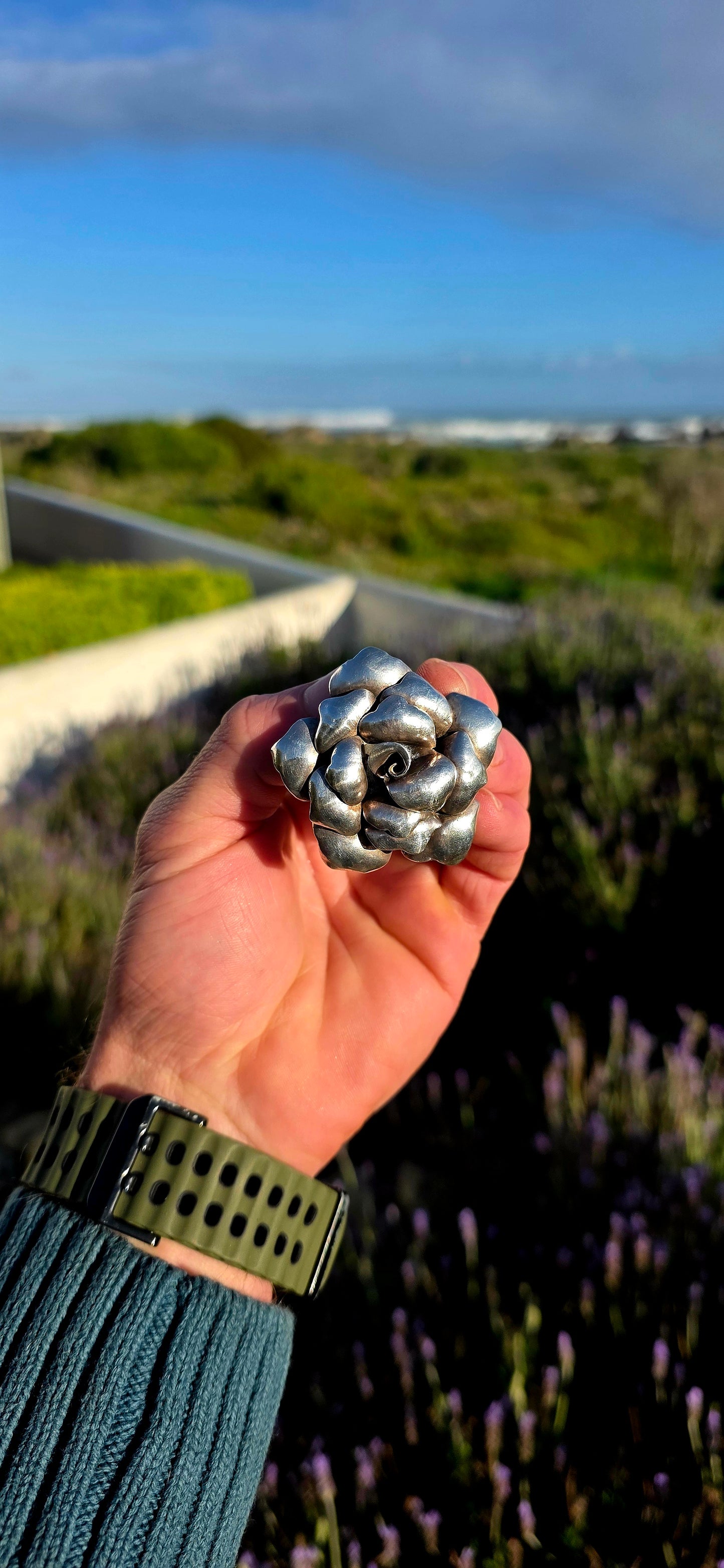Bold, romantic, and wonderfully sculptural... this vintage oversized sterling silver pendant captures the beauty of a blooming rose in an eye-catching three-dimensional design.