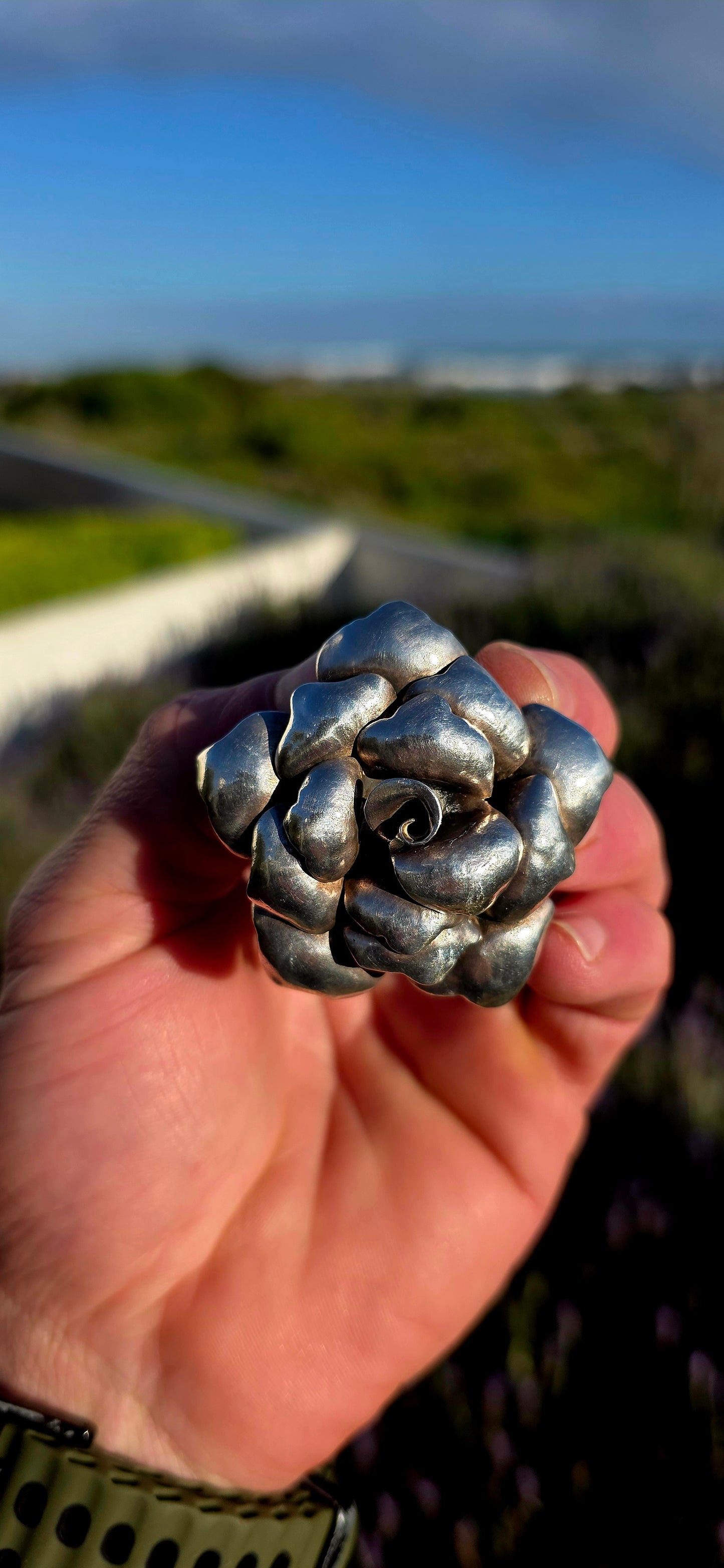 Bold, romantic, and wonderfully sculptural... this vintage oversized sterling silver pendant captures the beauty of a blooming rose in an eye-catching three-dimensional design.