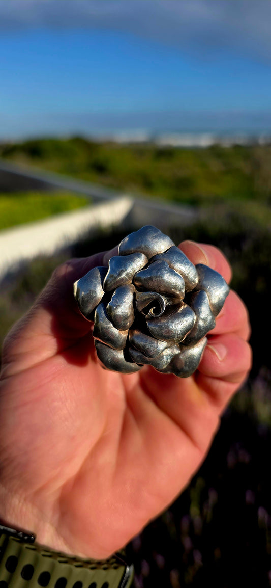 Bold, romantic, and wonderfully sculptural... this vintage oversized sterling silver pendant captures the beauty of a blooming rose in an eye-catching three-dimensional design.