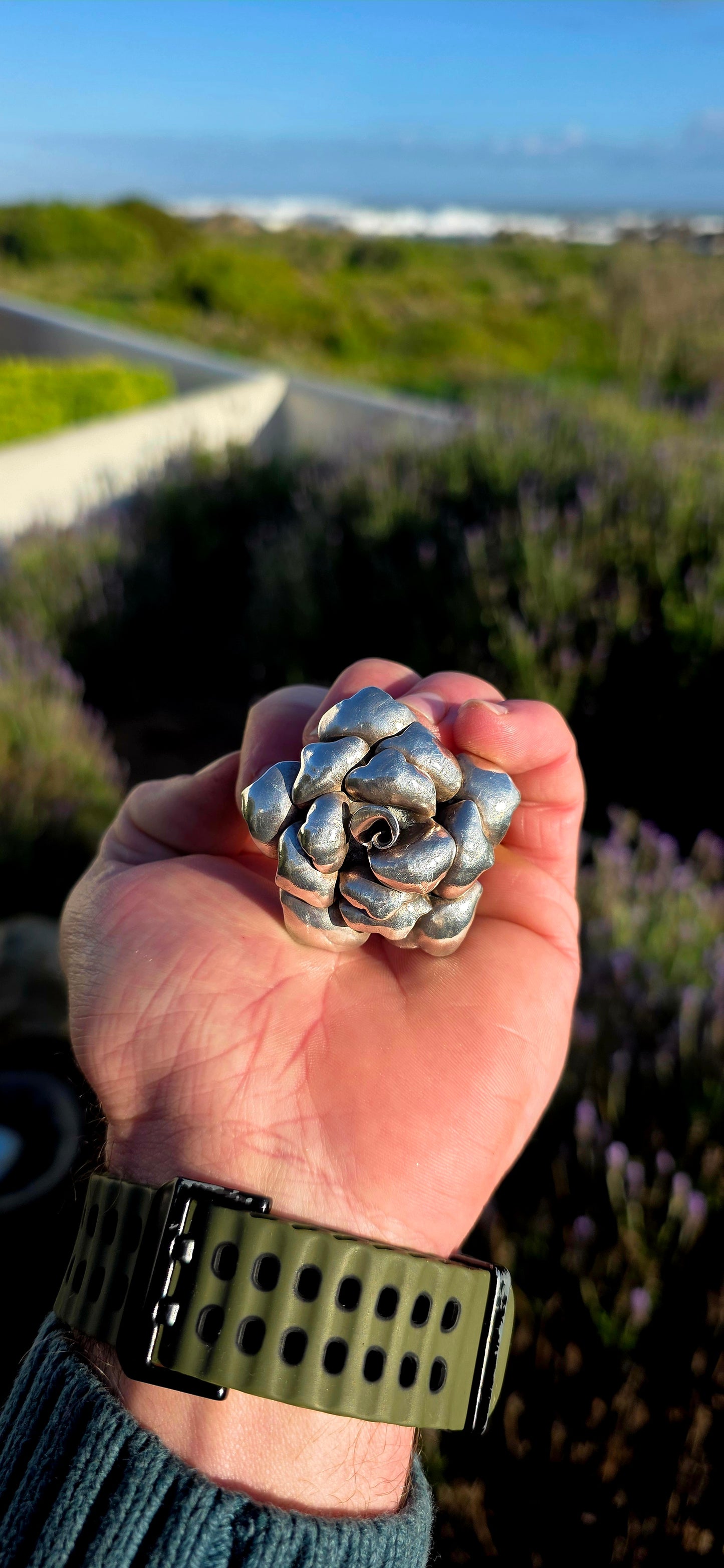 Bold, romantic, and wonderfully sculptural... this vintage oversized sterling silver pendant captures the beauty of a blooming rose in an eye-catching three-dimensional design.