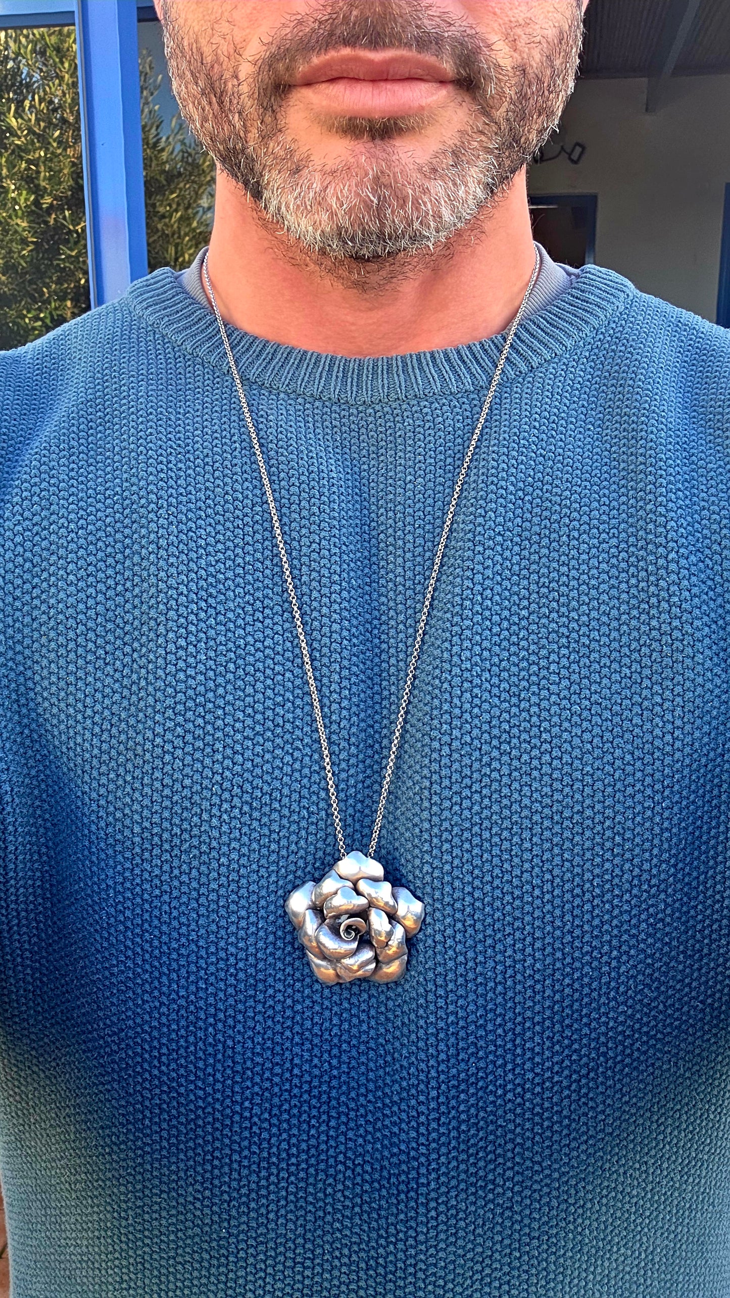 Bold, romantic, and wonderfully sculptural... this vintage oversized sterling silver pendant captures the beauty of a blooming rose in an eye-catching three-dimensional design.