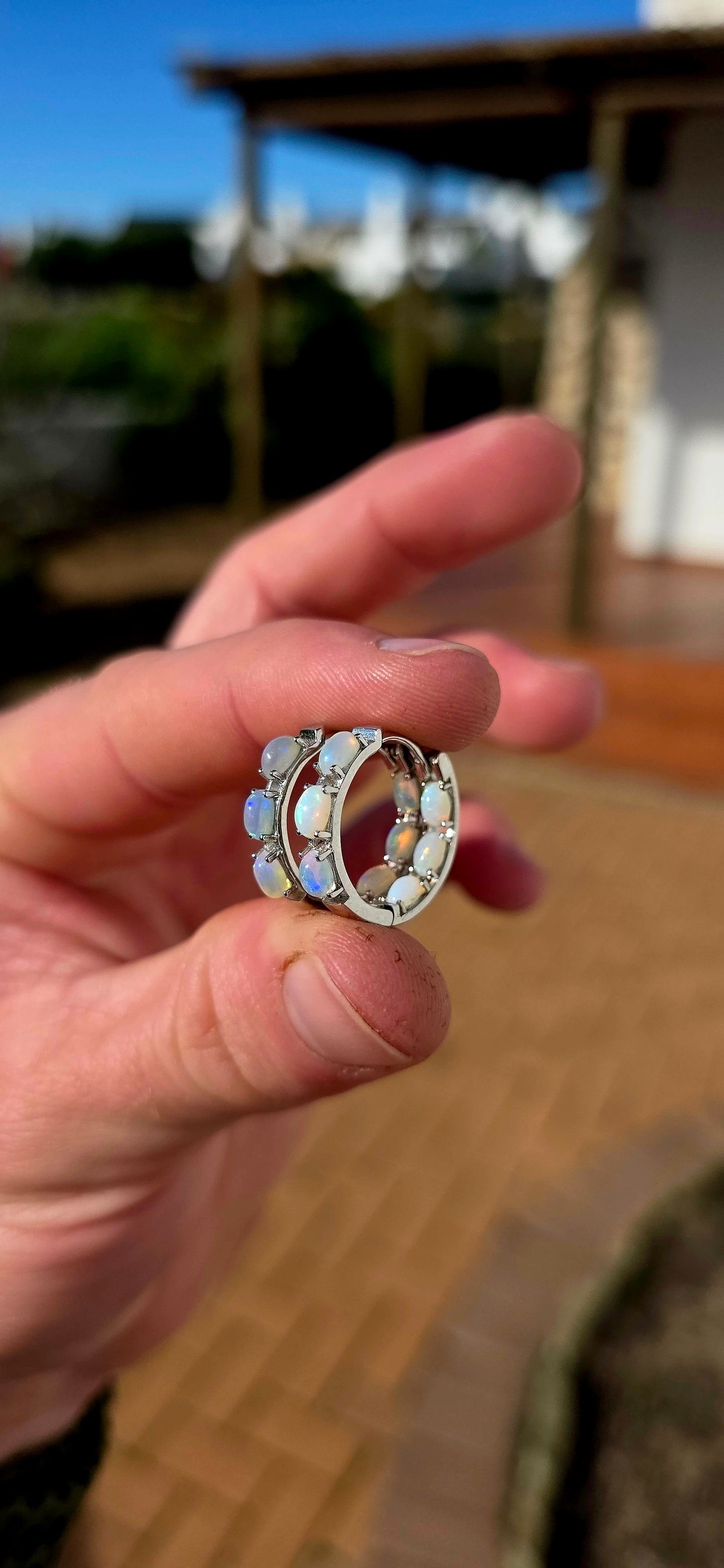 These sterling silver Ethiopian opal huggie earrings are pure magic... extremely elegant with a mesmerising display of colour that changes with every movement.