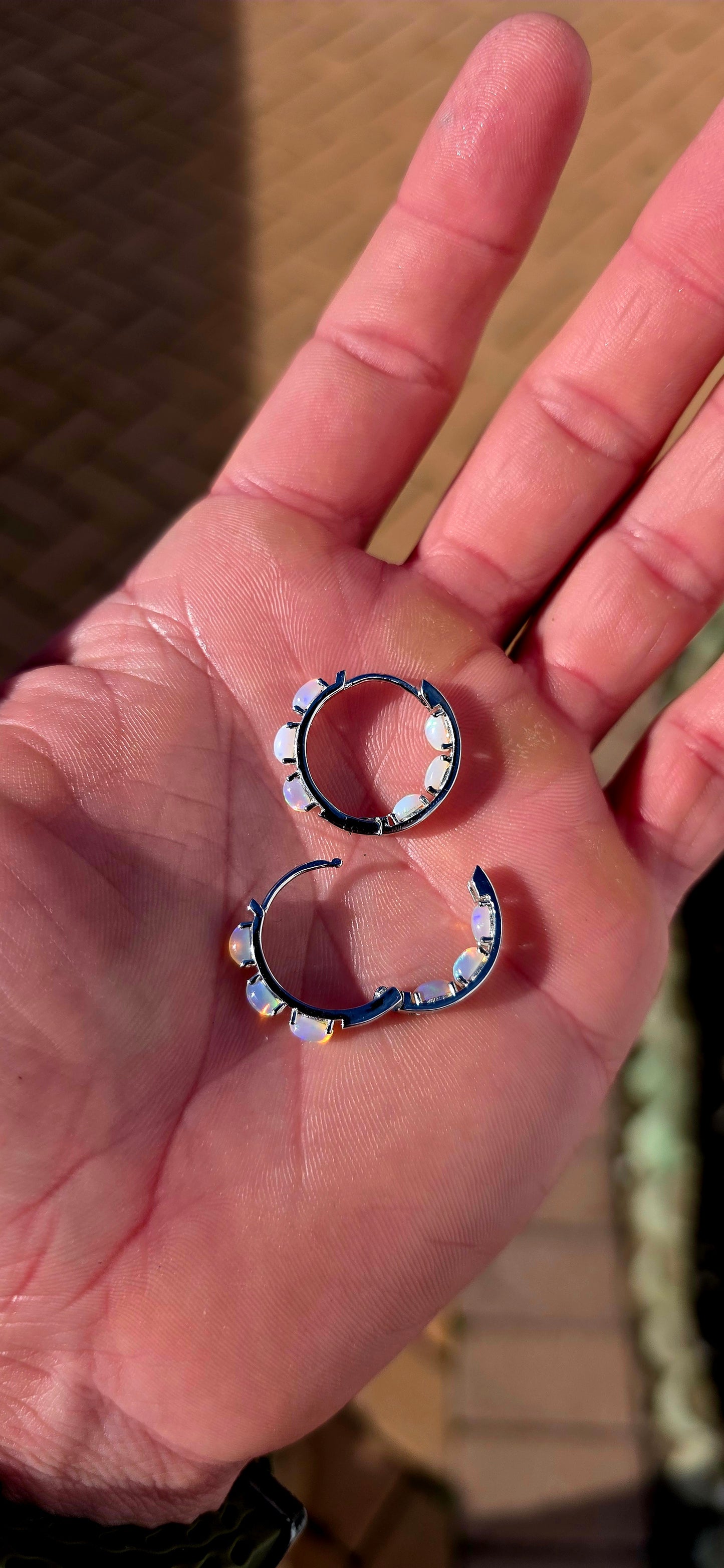 These sterling silver Ethiopian opal huggie earrings are pure magic... extremely elegant with a mesmerising display of colour that changes with every movement.