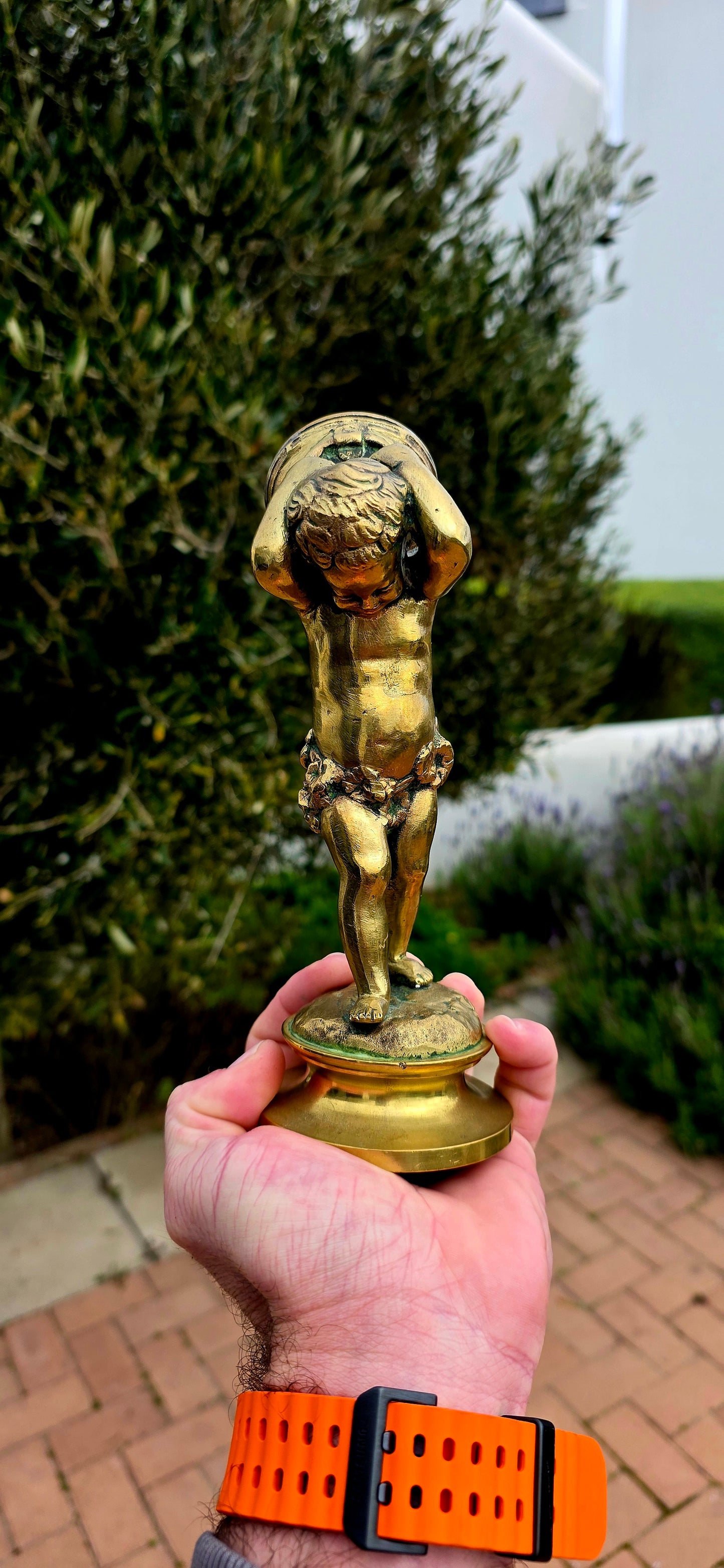 An exceptionally charming and highly collectible 19th-century Victorian bronze depicting the playful Cupid (Putto) joyfully carrying a musical drum upon his shoulders.