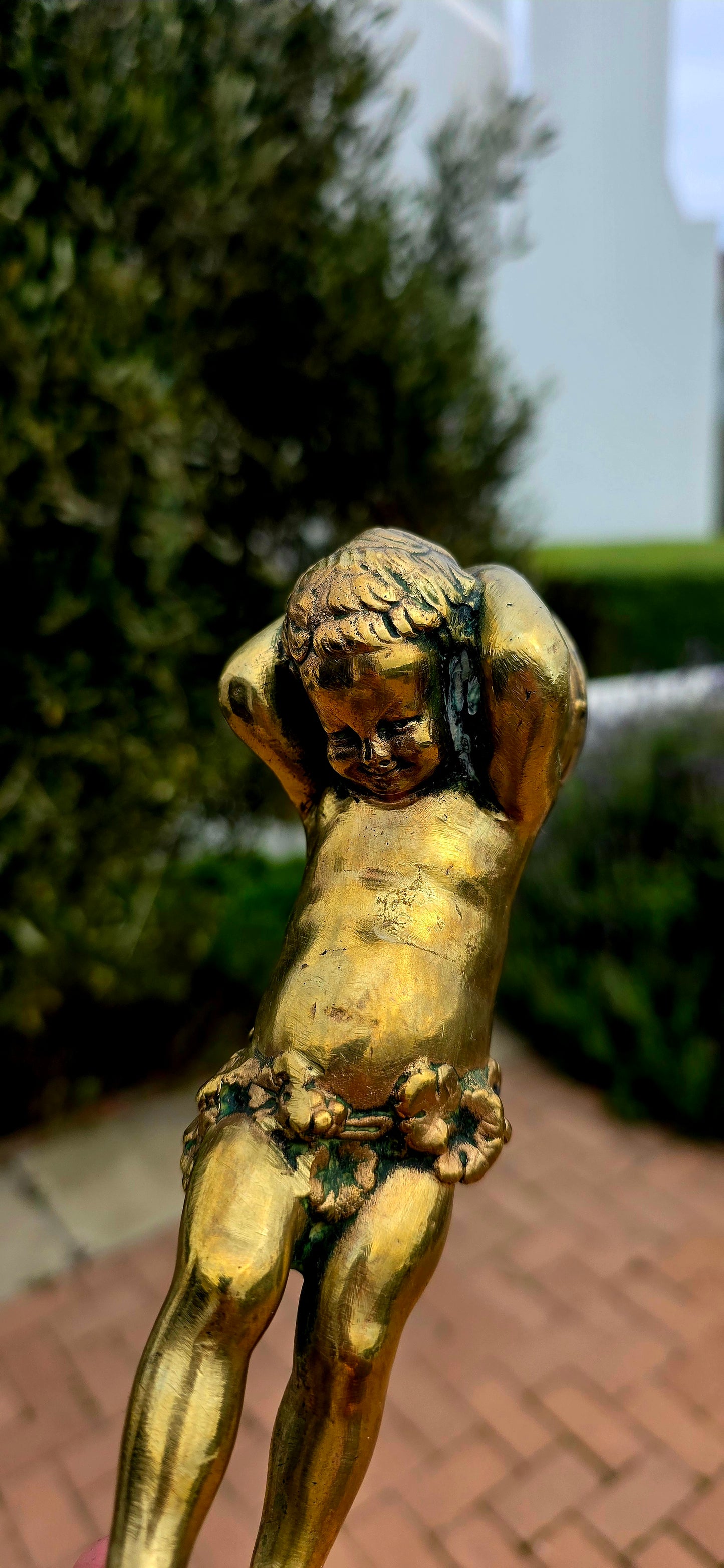 An exceptionally charming and highly collectible 19th-century Victorian bronze depicting the playful Cupid (Putto) joyfully carrying a musical drum upon his shoulders.