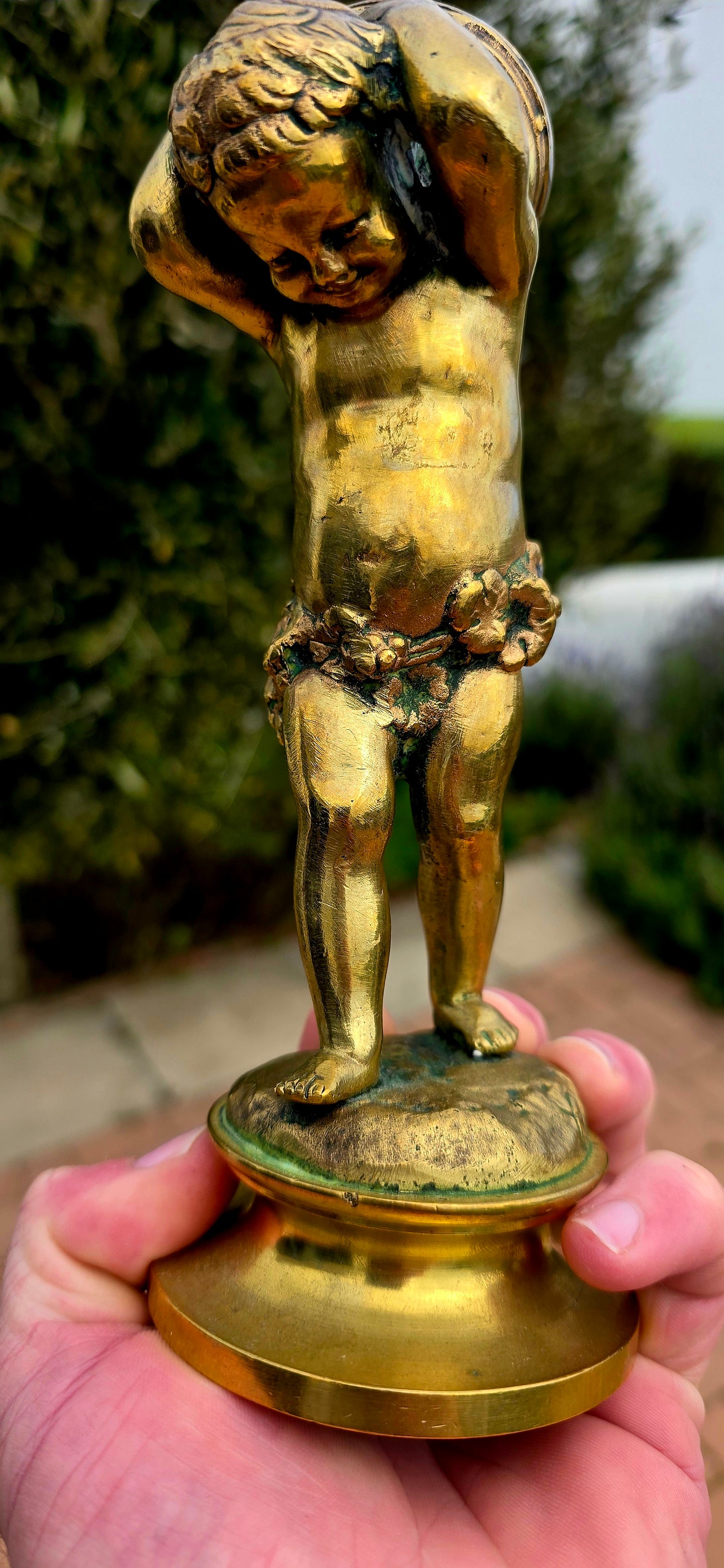 An exceptionally charming and highly collectible 19th-century Victorian bronze depicting the playful Cupid (Putto) joyfully carrying a musical drum upon his shoulders.