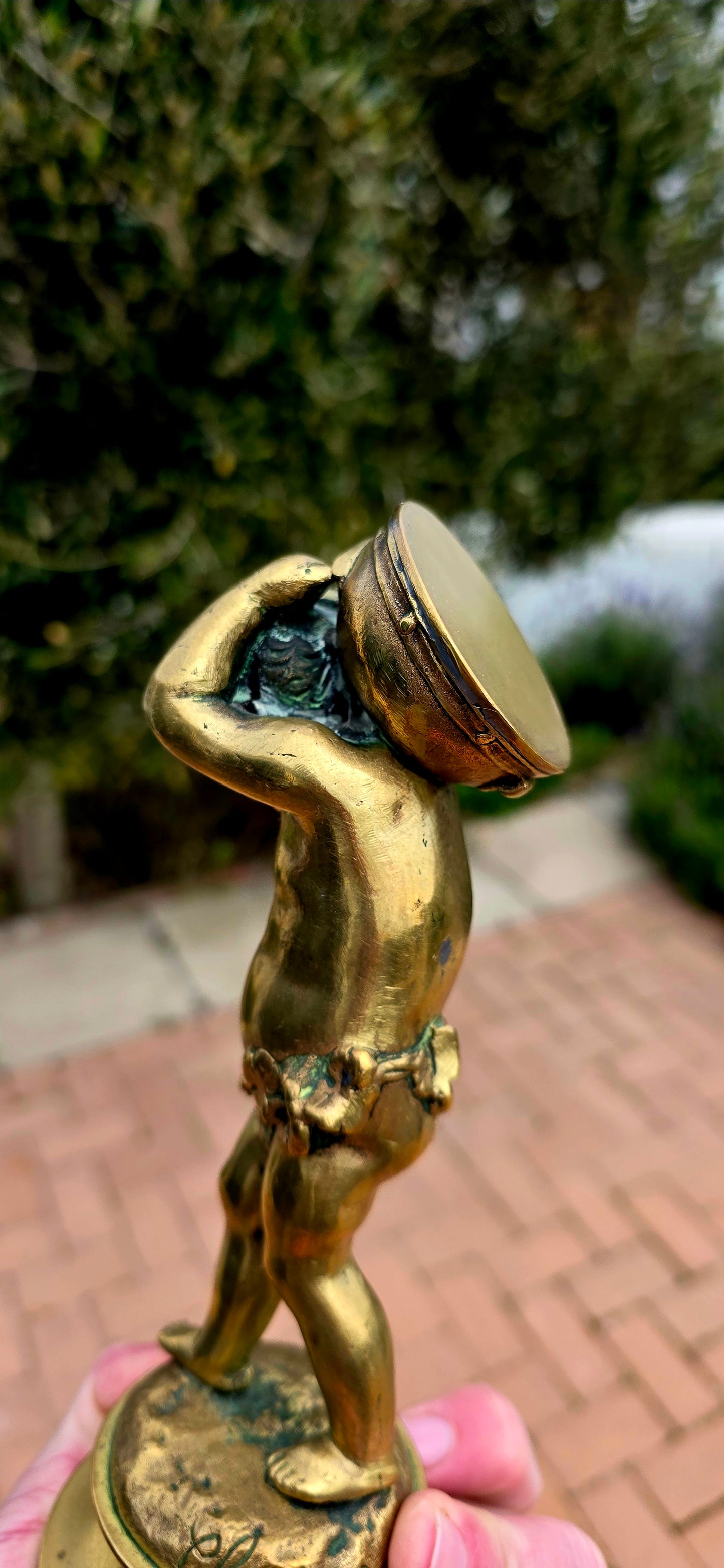 An exceptionally charming and highly collectible 19th-century Victorian bronze depicting the playful Cupid (Putto) joyfully carrying a musical drum upon his shoulders.