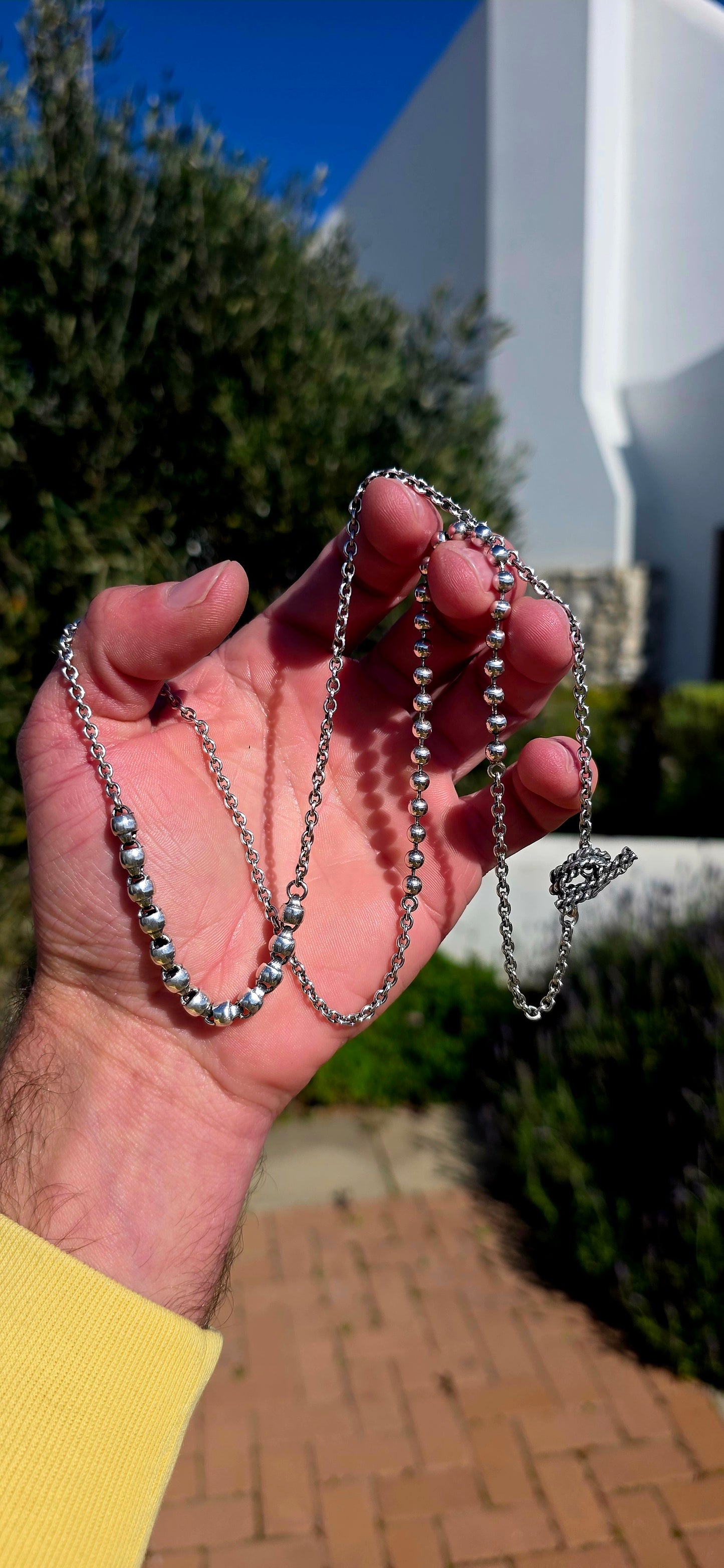 Minimalist, versatile, and effortlessly cool. This handcrafted sterling silver necklace features alternating round bead sections and classic belcher links, finished with a beautifully detailed artisan toggle clasp.