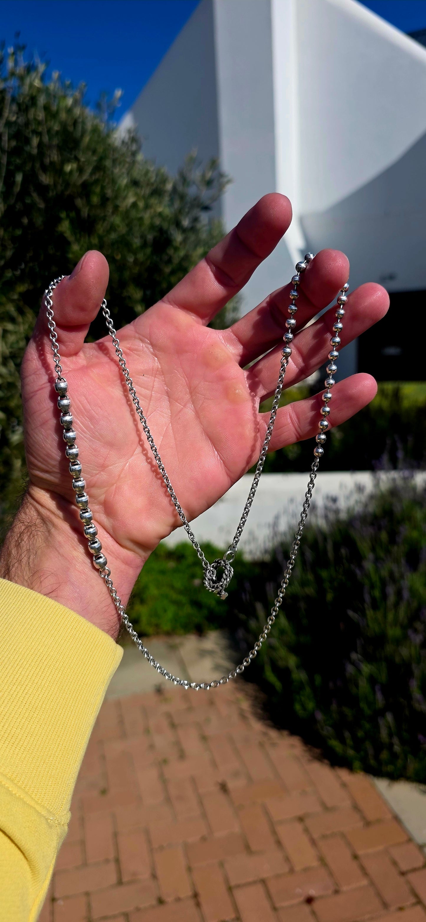 Minimalist, versatile, and effortlessly cool. This handcrafted sterling silver necklace features alternating round bead sections and classic belcher links, finished with a beautifully detailed artisan toggle clasp.