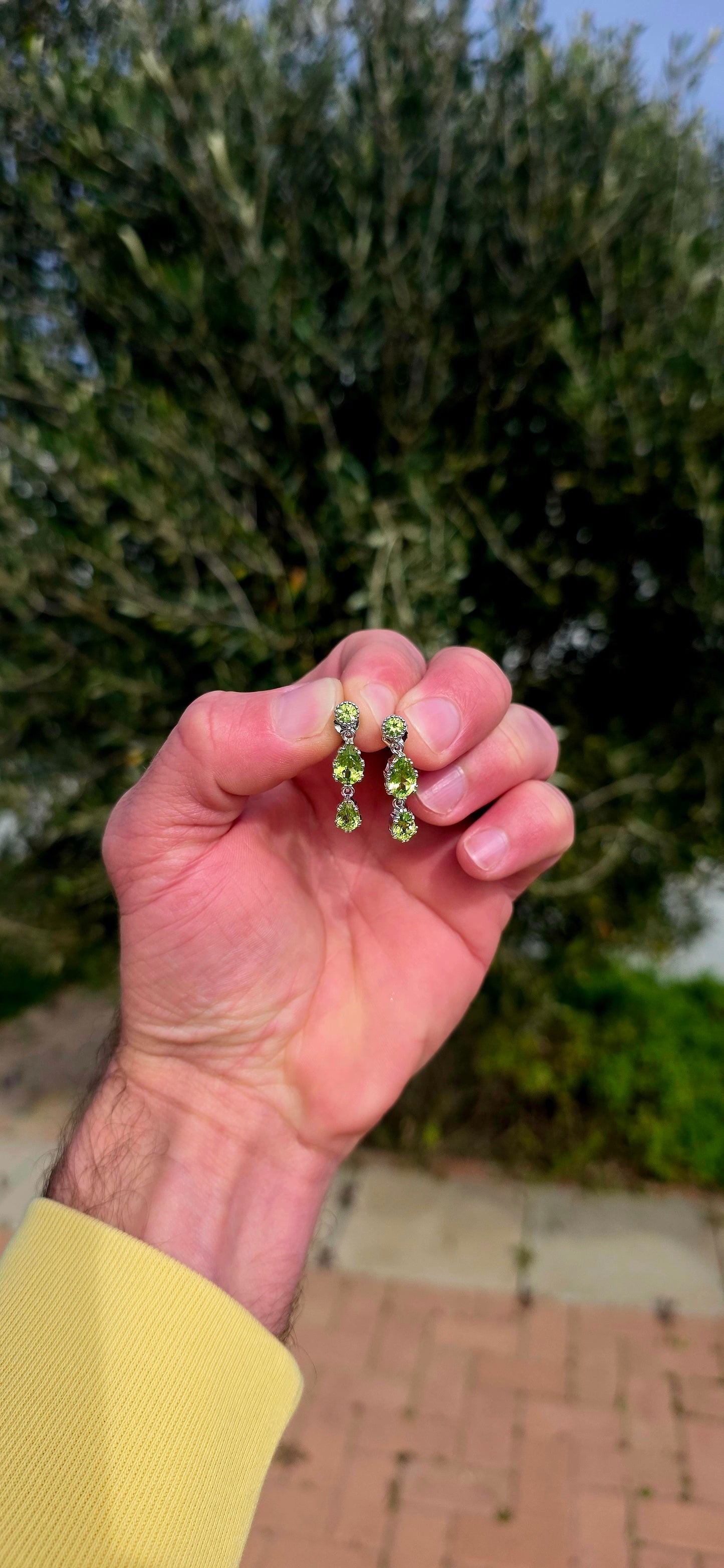 Fresh, vibrant, and full of graceful movement... these elegant sterling silver drop earrings celebrate the captivating beauty of natural peridot.